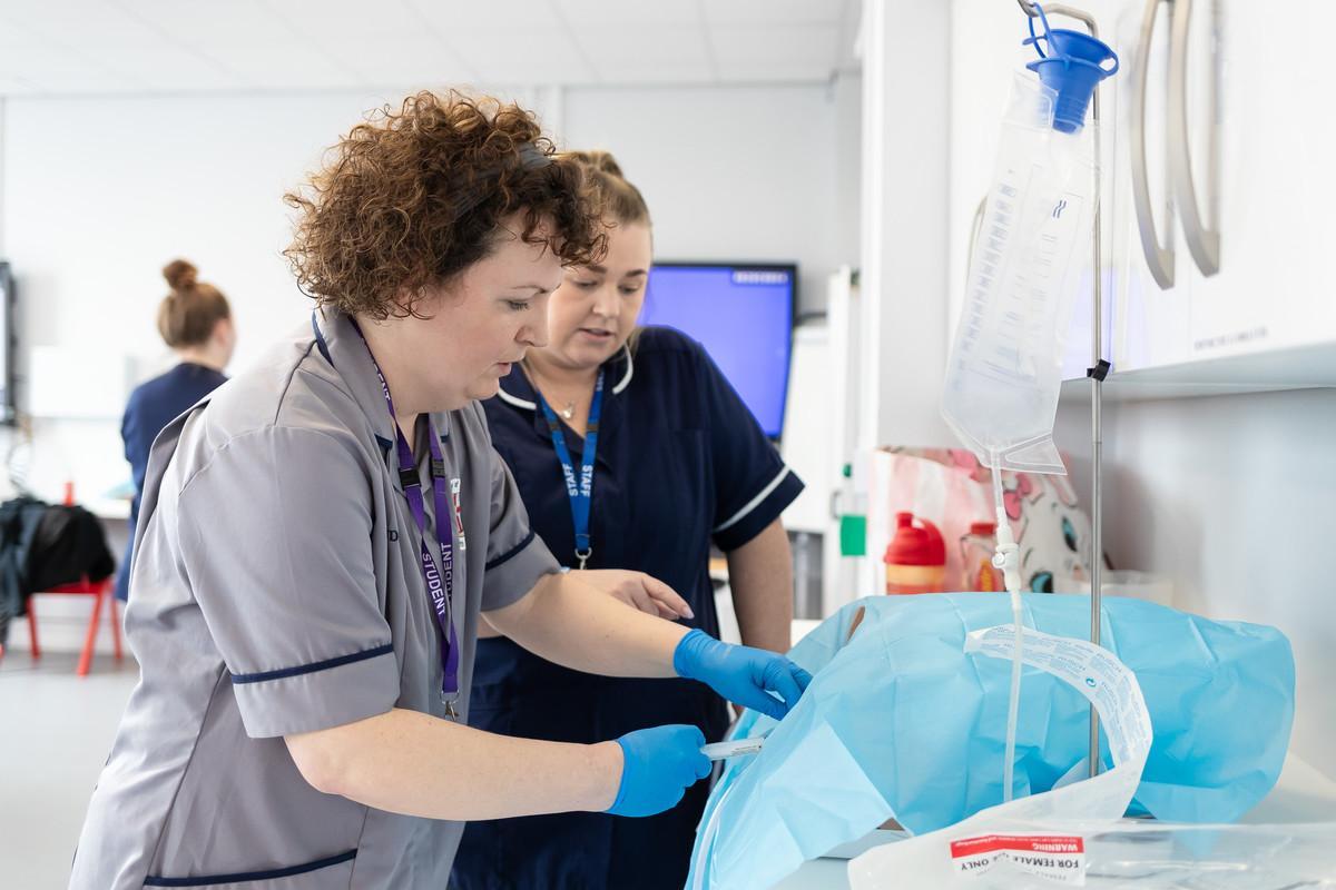 Nursing students developing advanced clinical skills in a simulation ward at the University of Chester, reflecting the Specialist Community Public Health Nursing – Health Visiting PGDip and its focus on public health, family support, safeguarding and community healthcare practice.