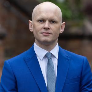 James Ruddock stood outside in a blue suit and tie