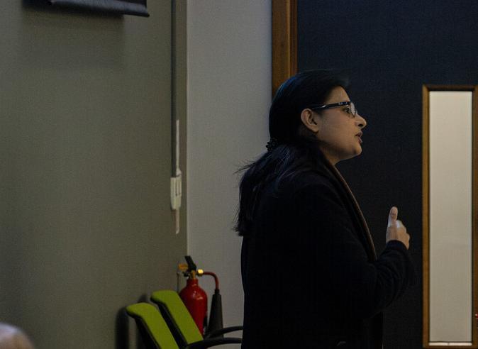 A woman presenting at the Faculty of Science, Business and Enterprise's Research Day event.