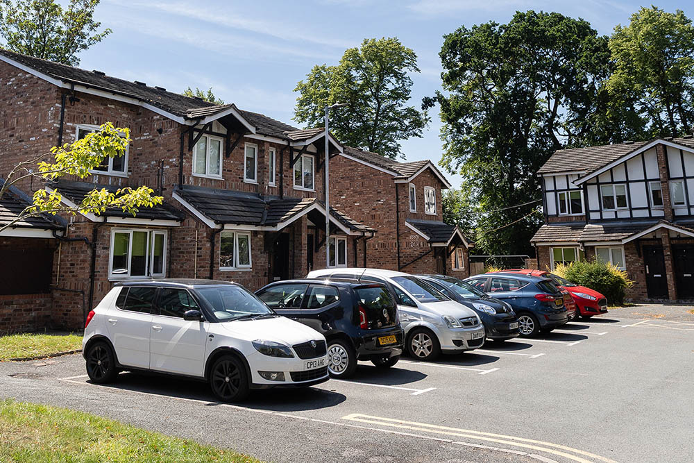 Vehicles parked outside Church College Close, Exton Park
