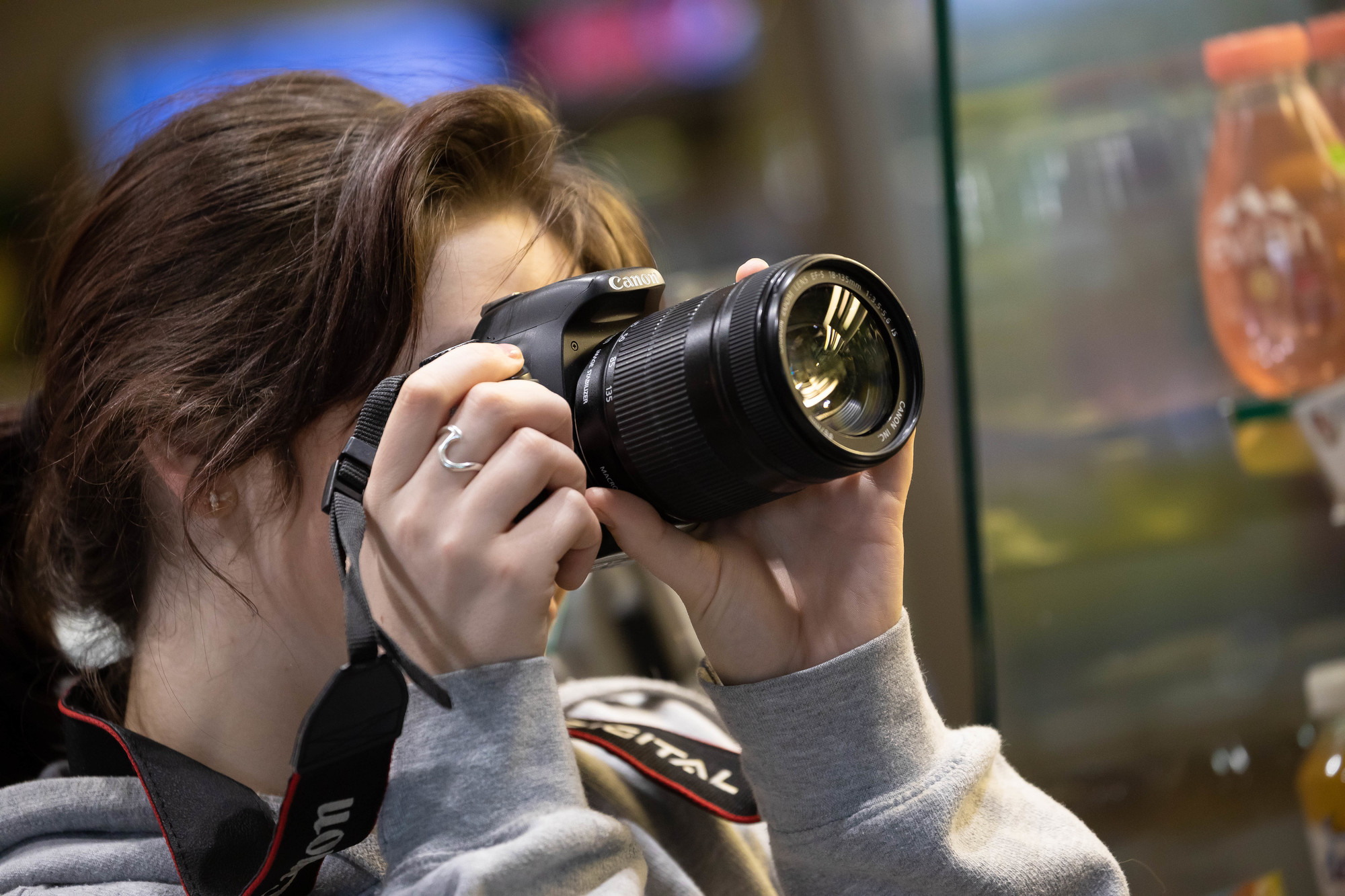 Student holding camera pointing upwards