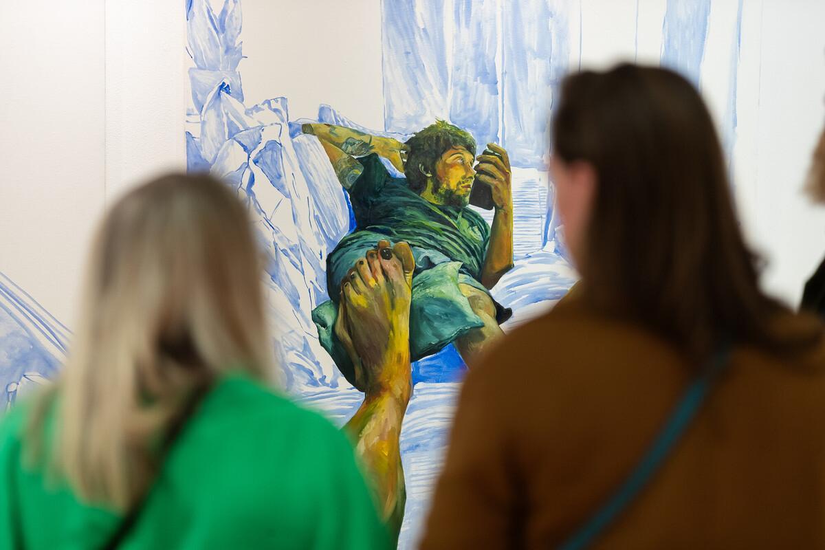 Students viewing a contemporary painting at a fine art exhibition, showcasing creative expression and artistic study for a Fine Art BA (Hons) degree.