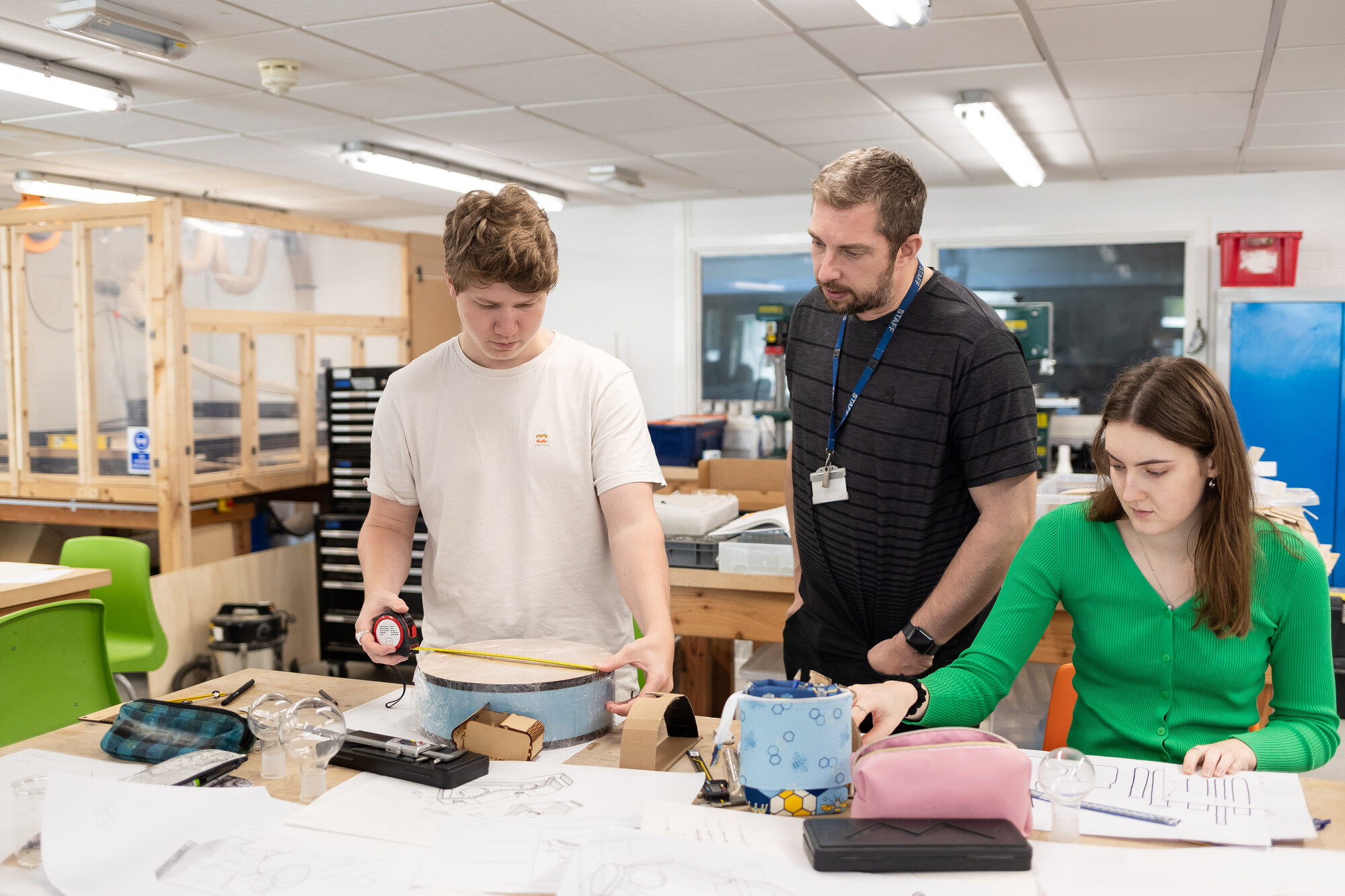 Lecturer overseeing the work done by two students