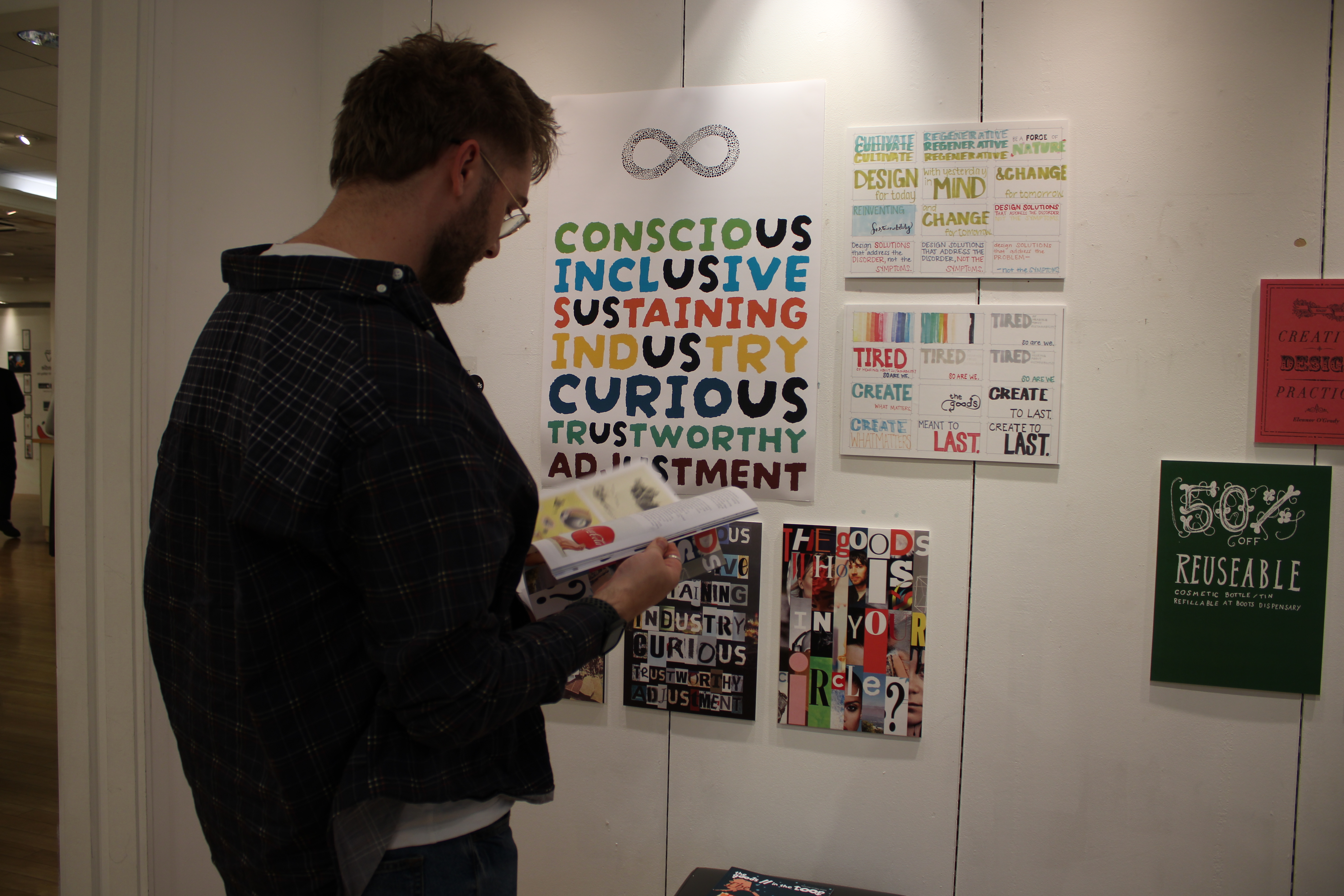 A person looking at graphic design work inside exhibition