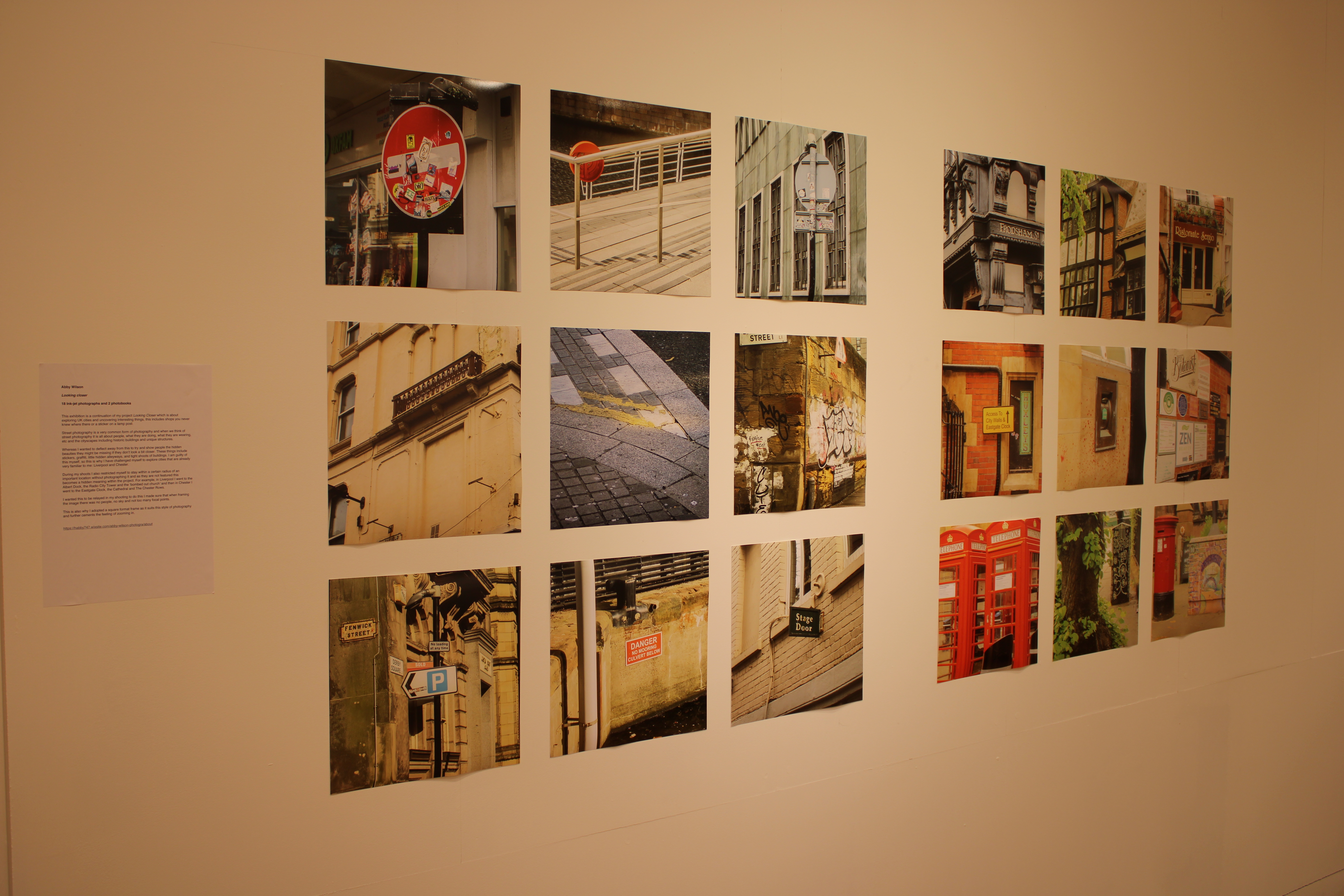 Photos on wall display inside gallery