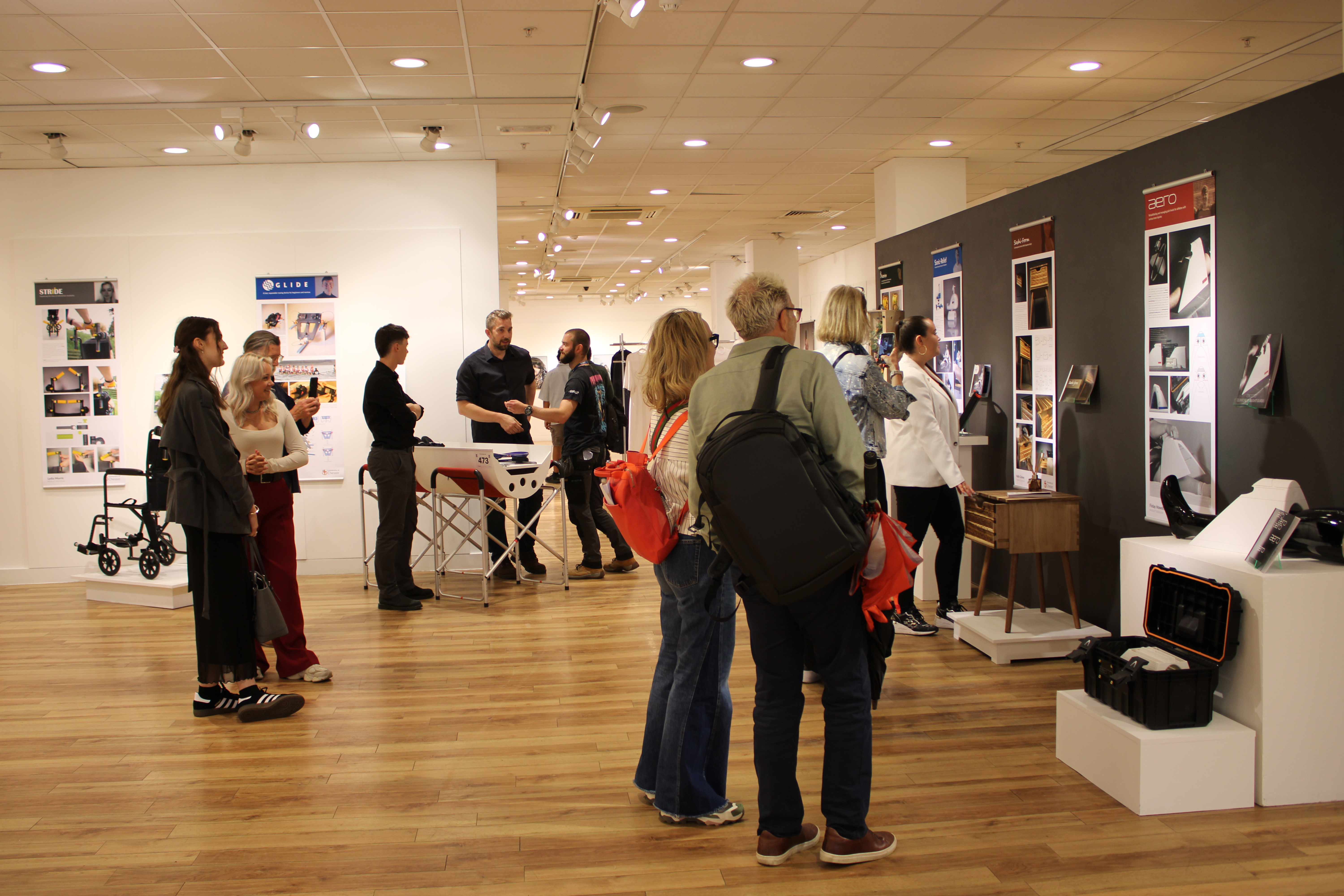 People looking at product designs on display