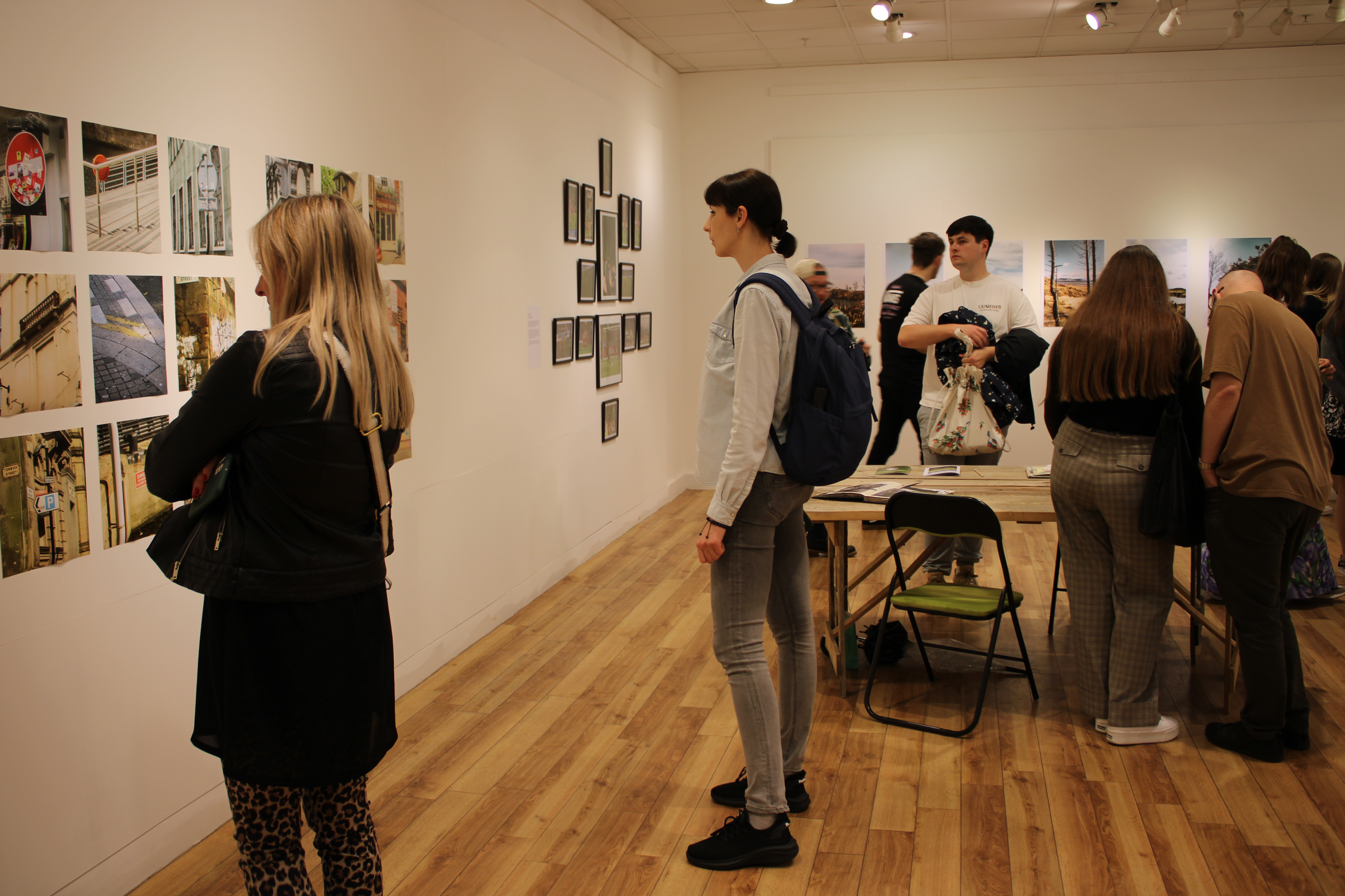 People looking at photograph in gallery