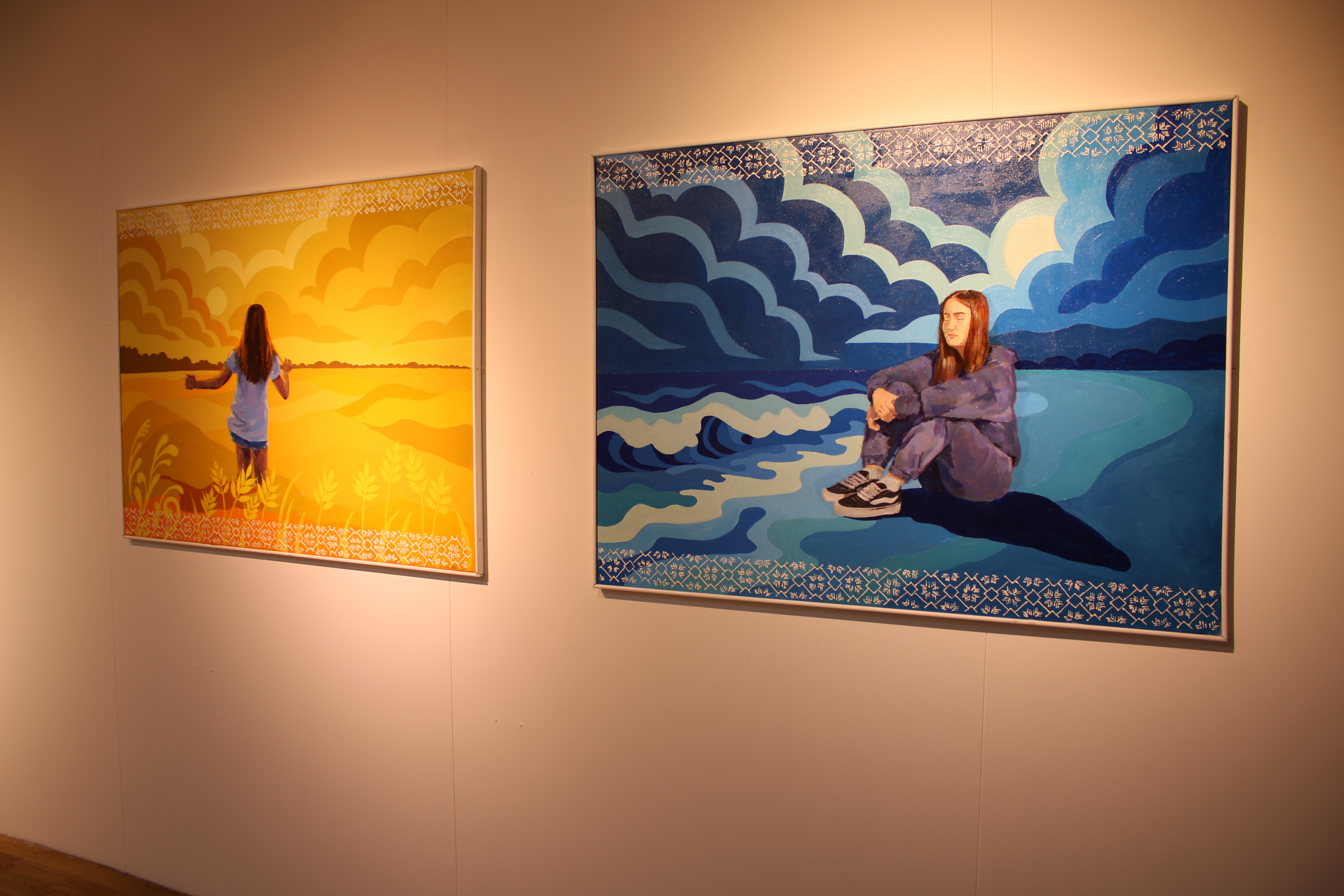 Two pieces of artwork on display inside a gallery