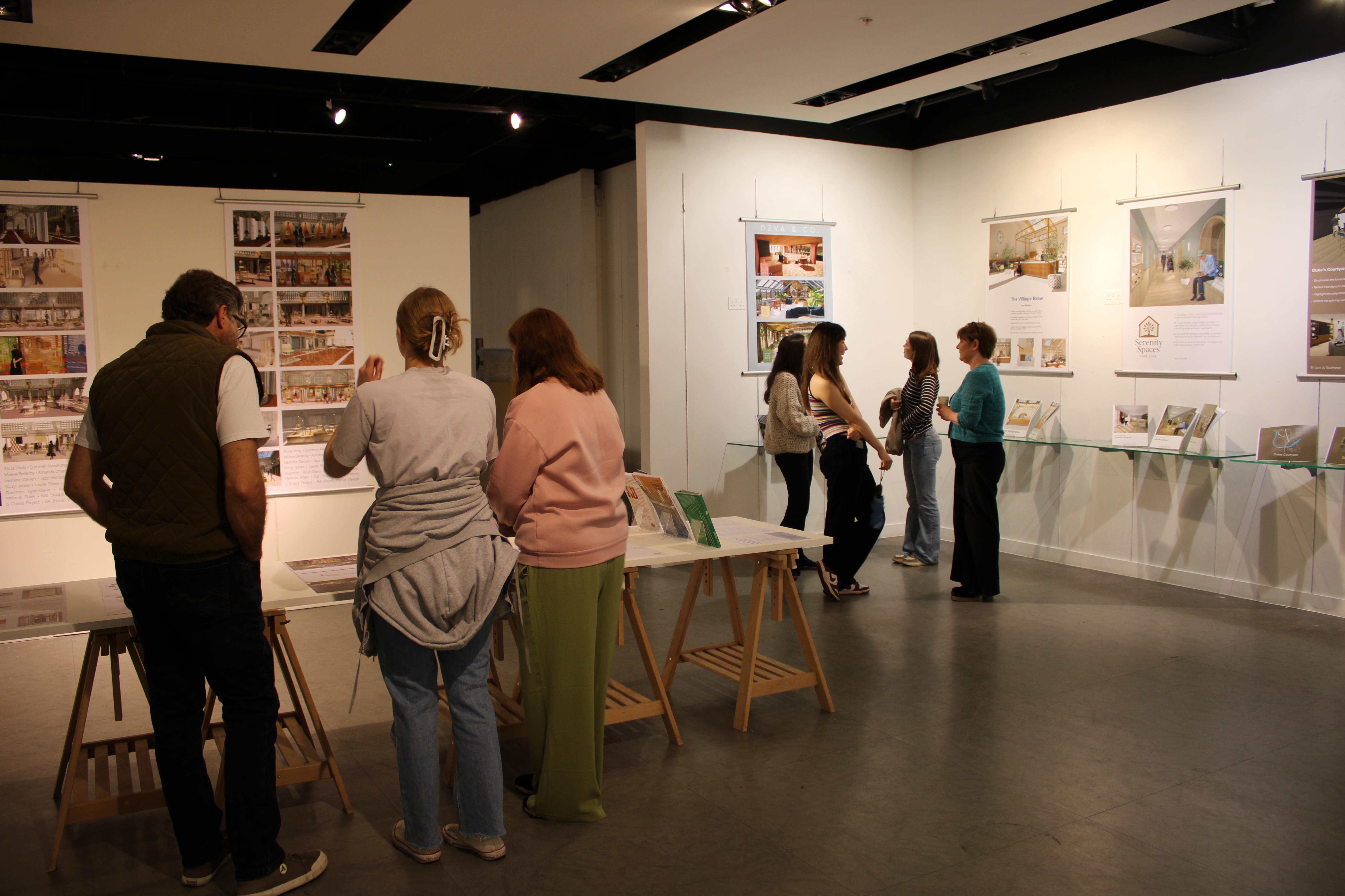 People looking at interior designs inside exhibition
