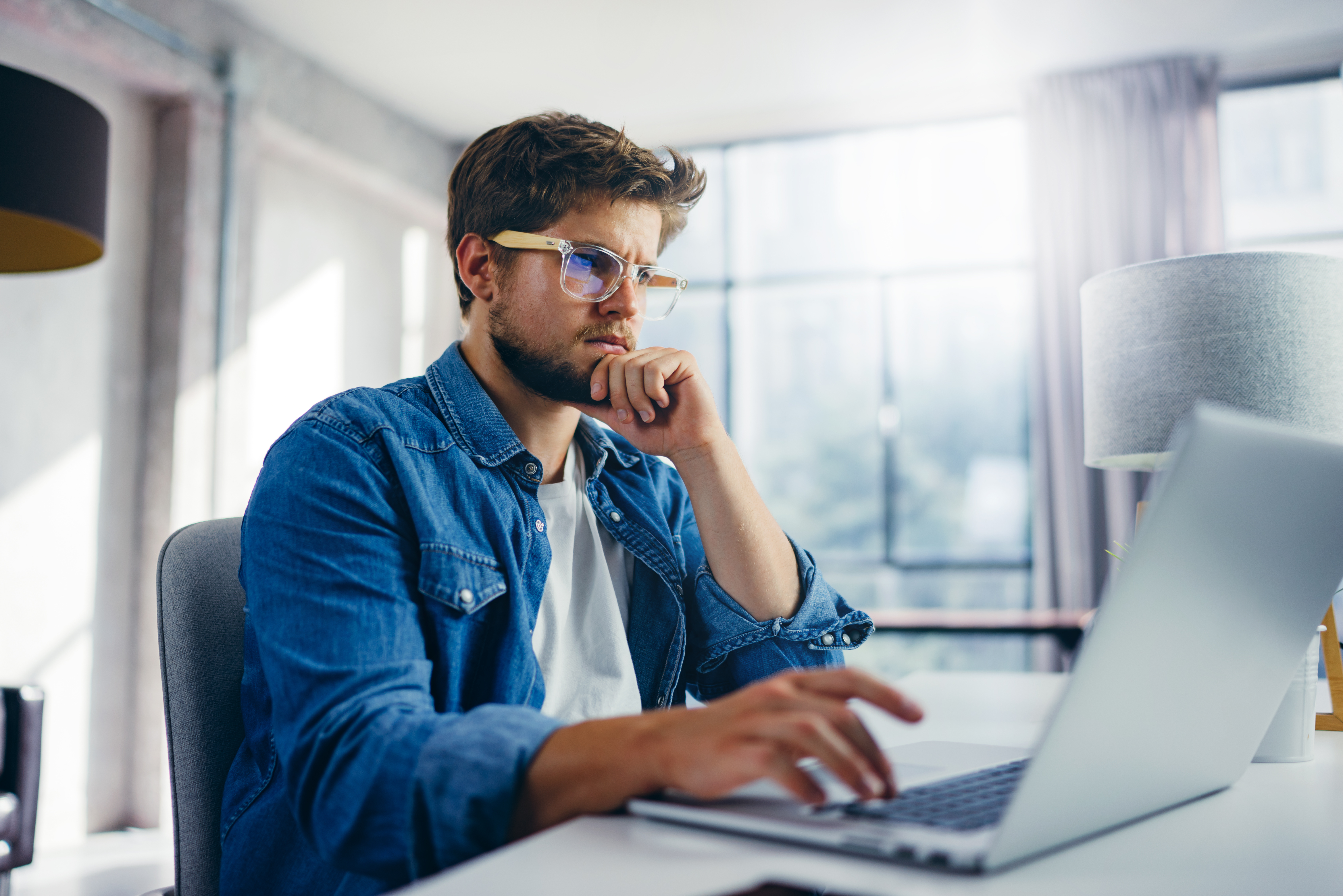 Man typing on laptop.