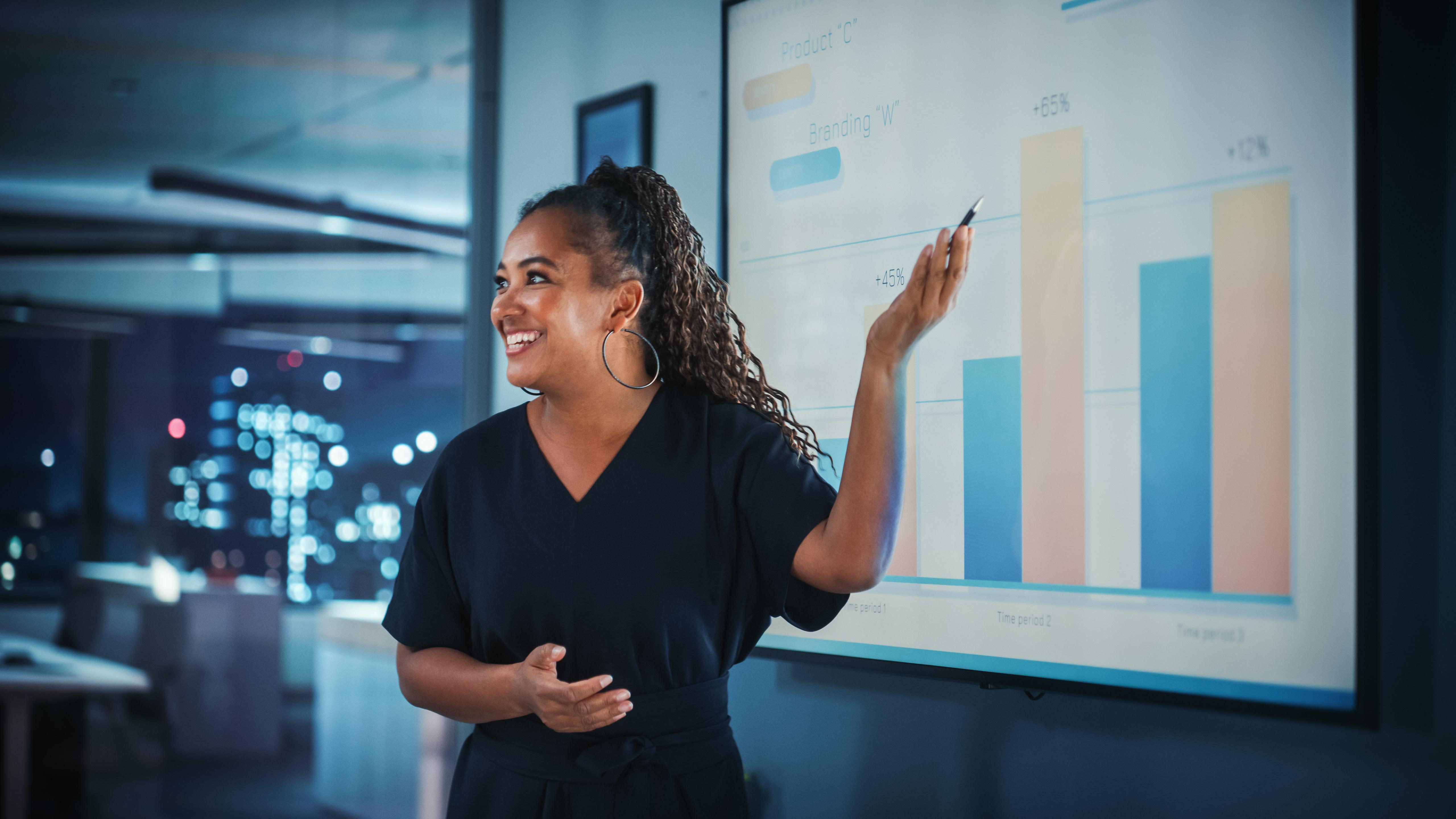 Student of a Business Management BA degree showcasing career-ready skills such as teamwork, strategy, and problem-solving in a professional setting.