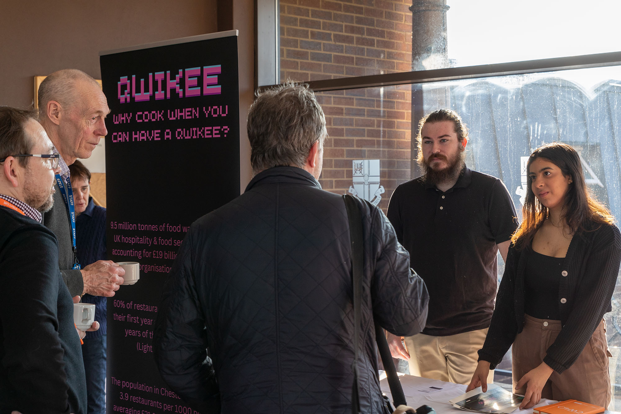 Students presenting their business to members of the public
