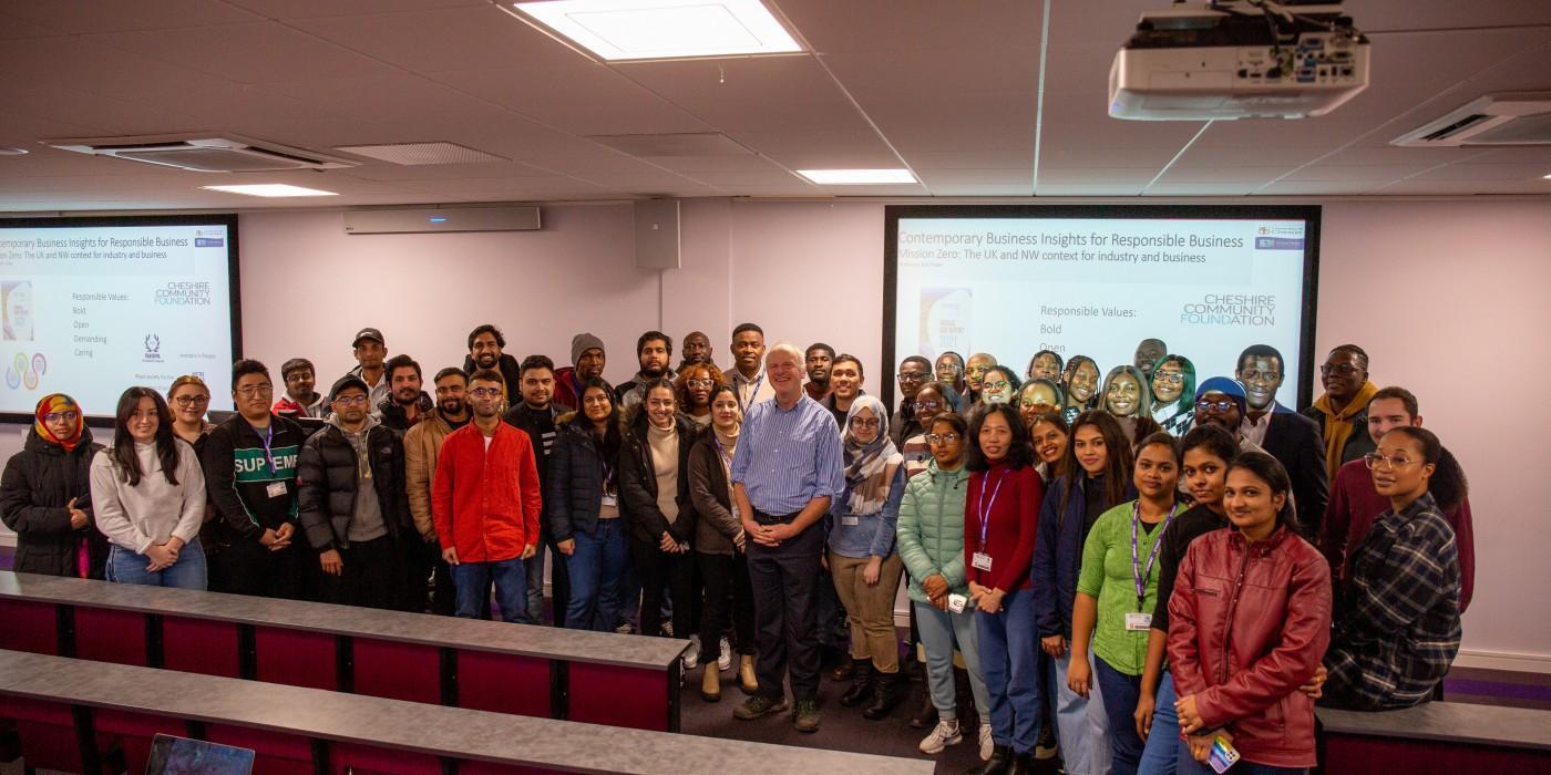 Professional engaged in analytical problem-solving and strategic planning using complex calculations on a whiteboard in a modern learning environment. Image representing the MBA with Specialism in International Human Resource Management at the University of Chester.