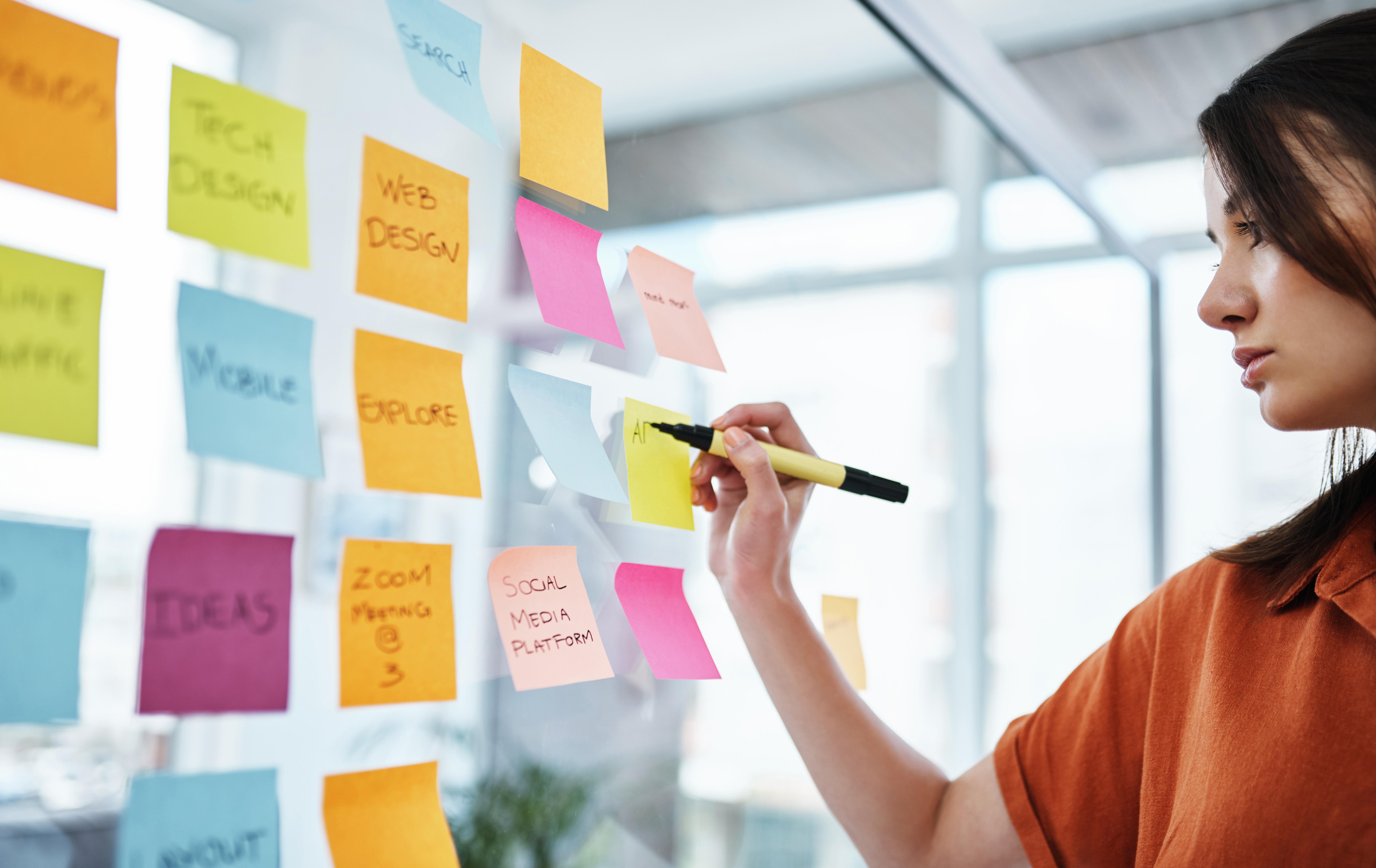 Student developing a digital marketing strategy using a creative planning board with notes on web design, social media, search and branding, reflecting Marketing Management MSc study at the University of Chester.