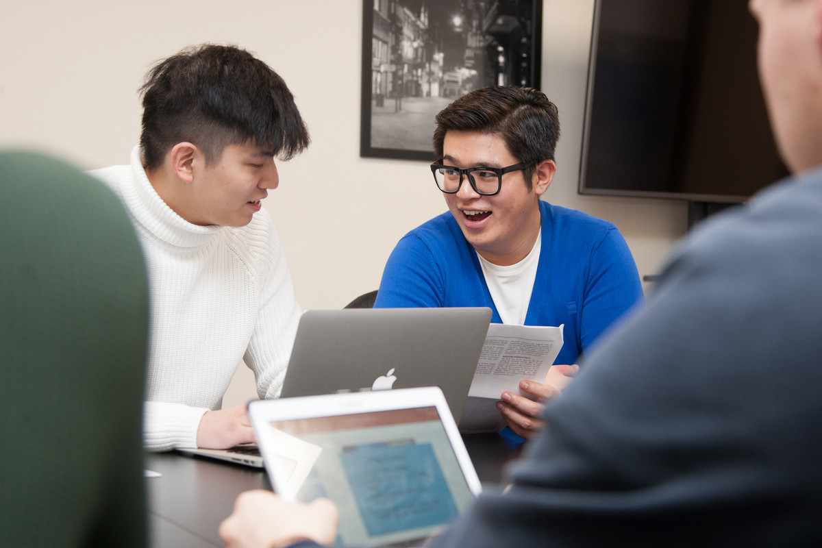 Two students using a laptop