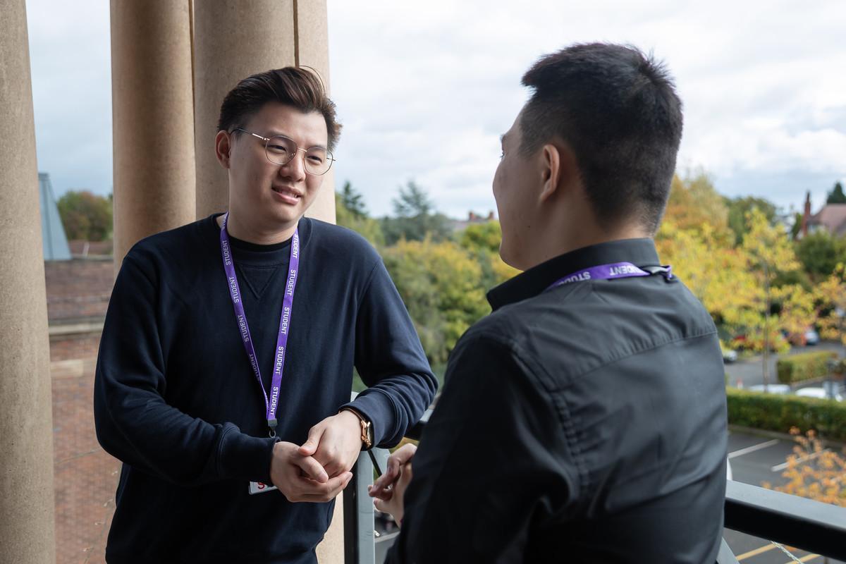 Students discussing ideas on campus, representing the Modern Languages MRes at the University of Chester and its focus on language research and intercultural communication.
