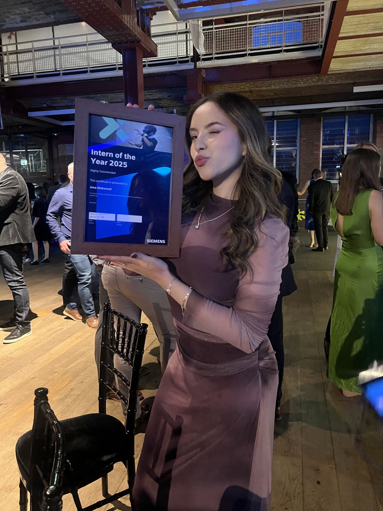 Jana Mohamed holding her Intern of the Year 2025 award