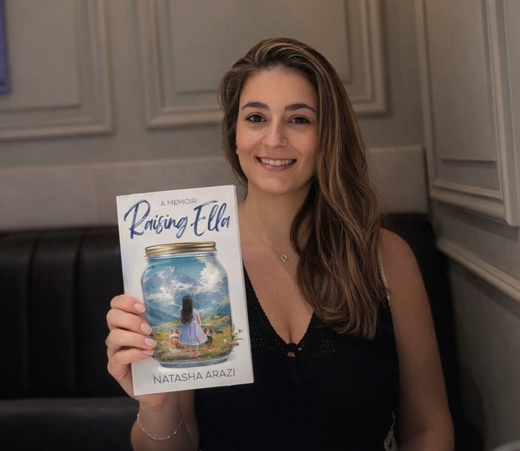 An Education student holds a book called Raising Ella