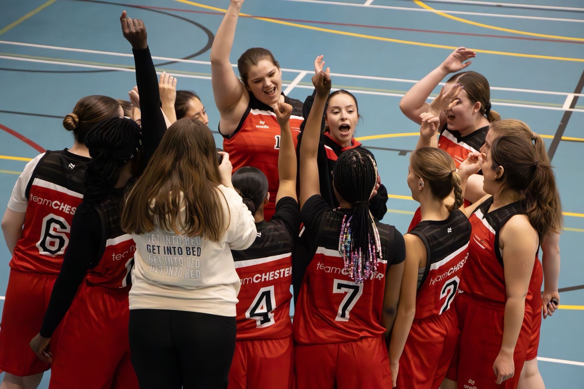 The University of Chester Women's Basketball Team celebrating on court