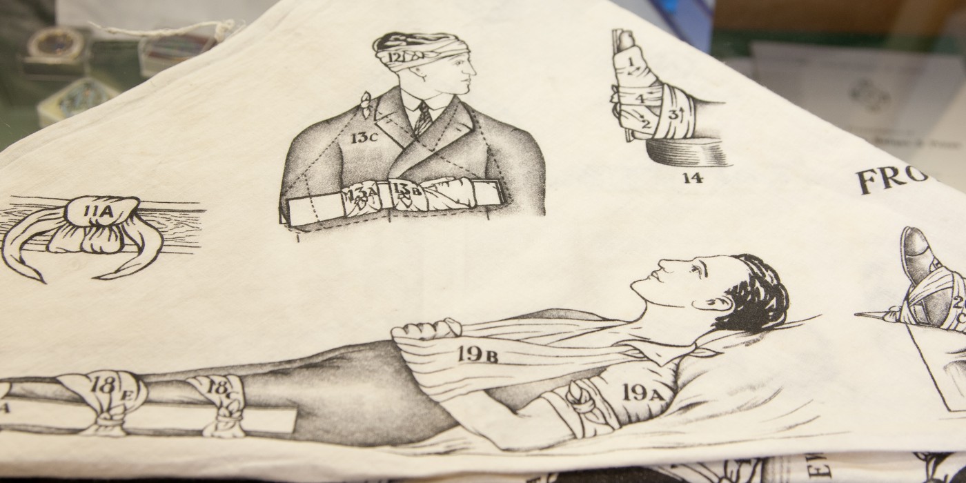 Historic cloth with drawings of men and body parts dressed in bandages.