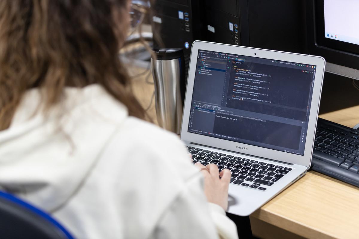 Computer Science (Conversion) MSc at University of Chester, showing practical coding and programming skills development on a laptop for careers in software development and IT.