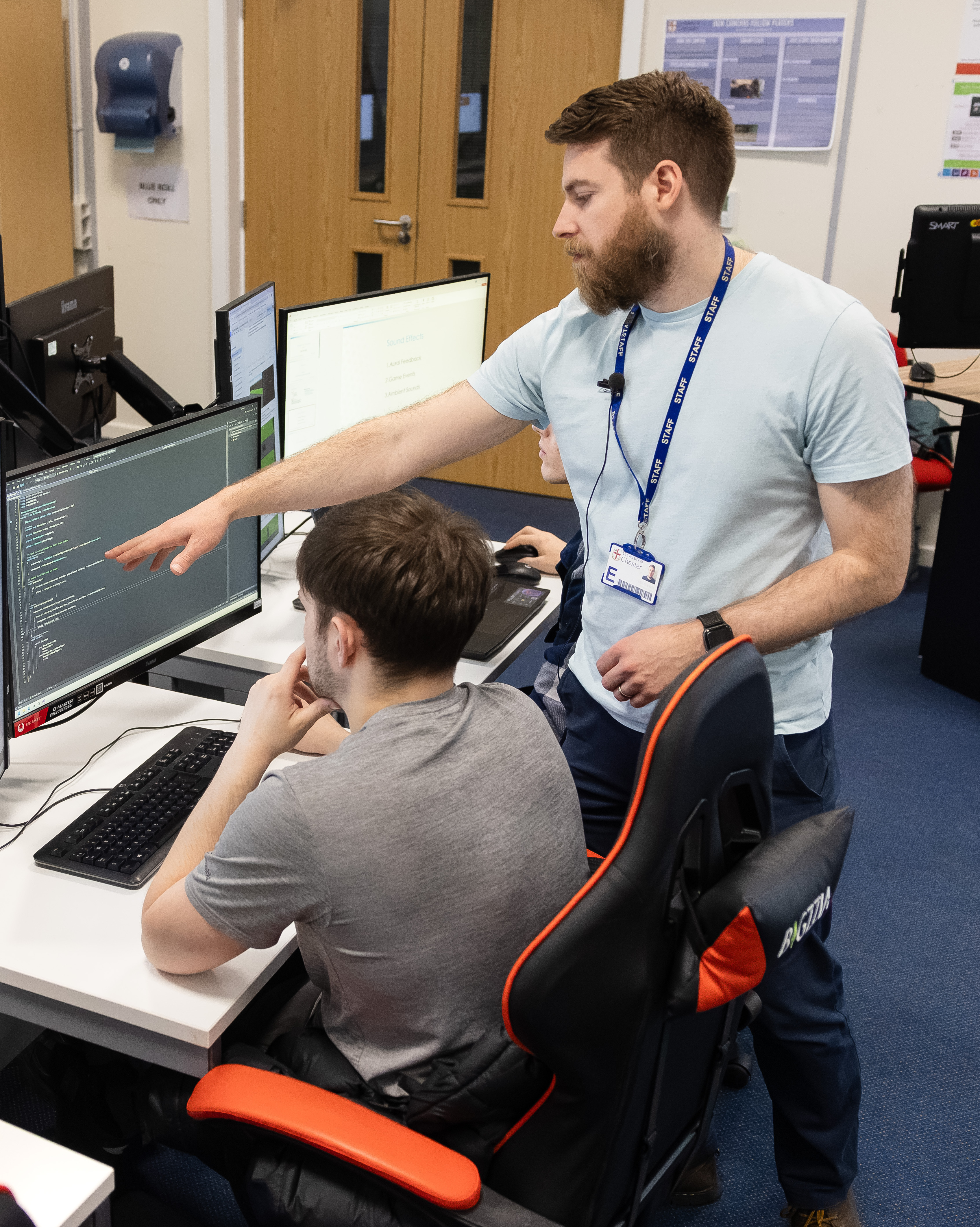 A staff member and a student in a gaming session