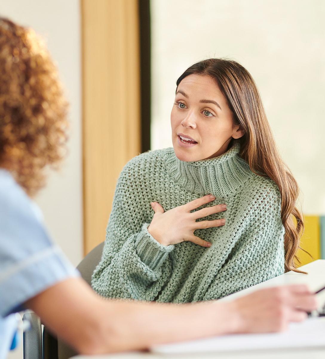 Student practicing counselling skills during a counselling and psychology degree session, talking with a professional therapist in a university setting.