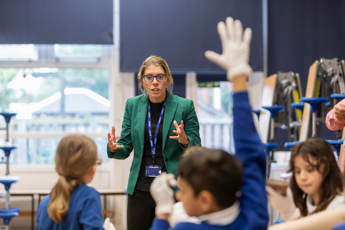 teacher talking with younger students