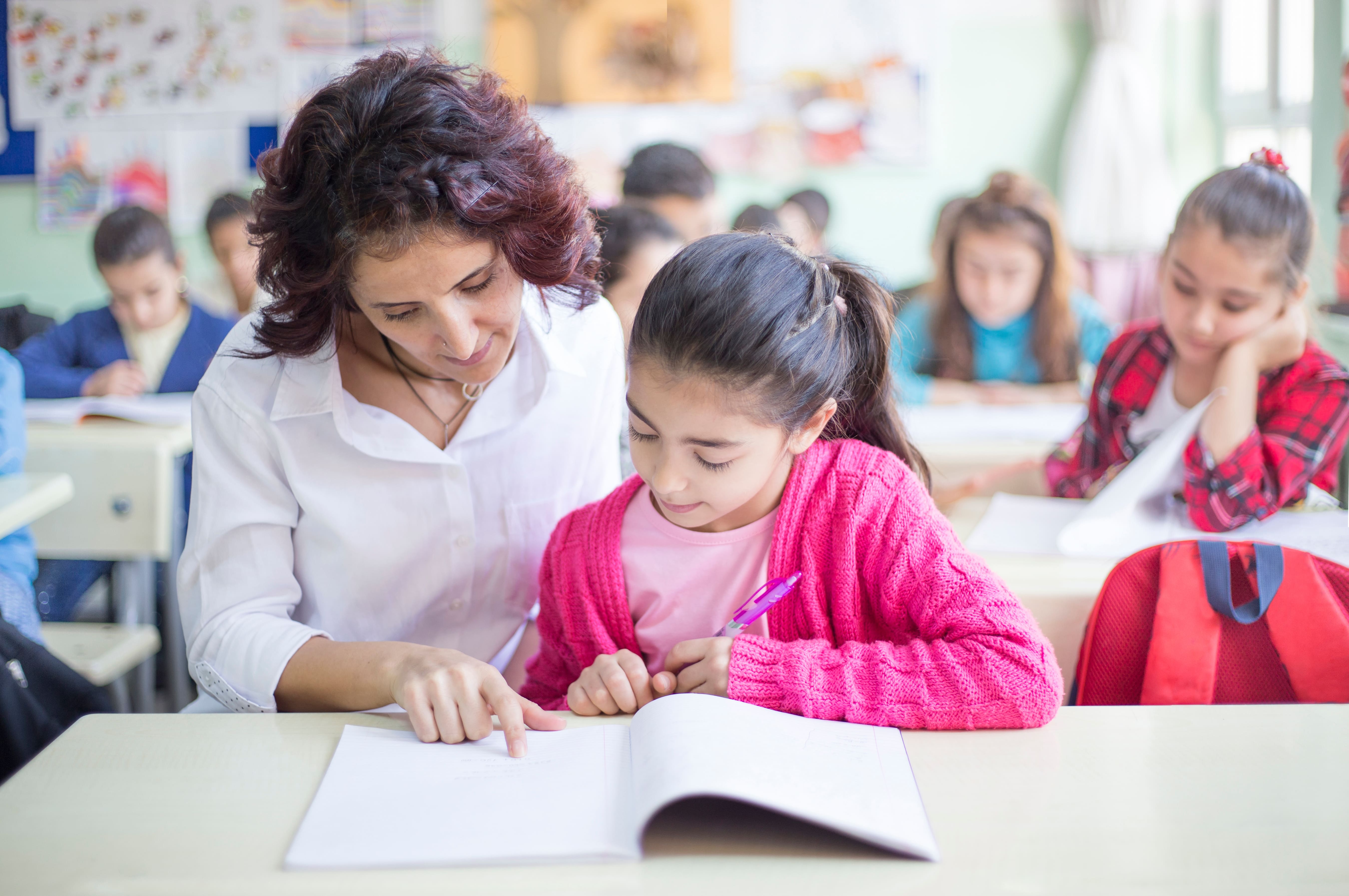 Schoolgirl and teacher in classroom