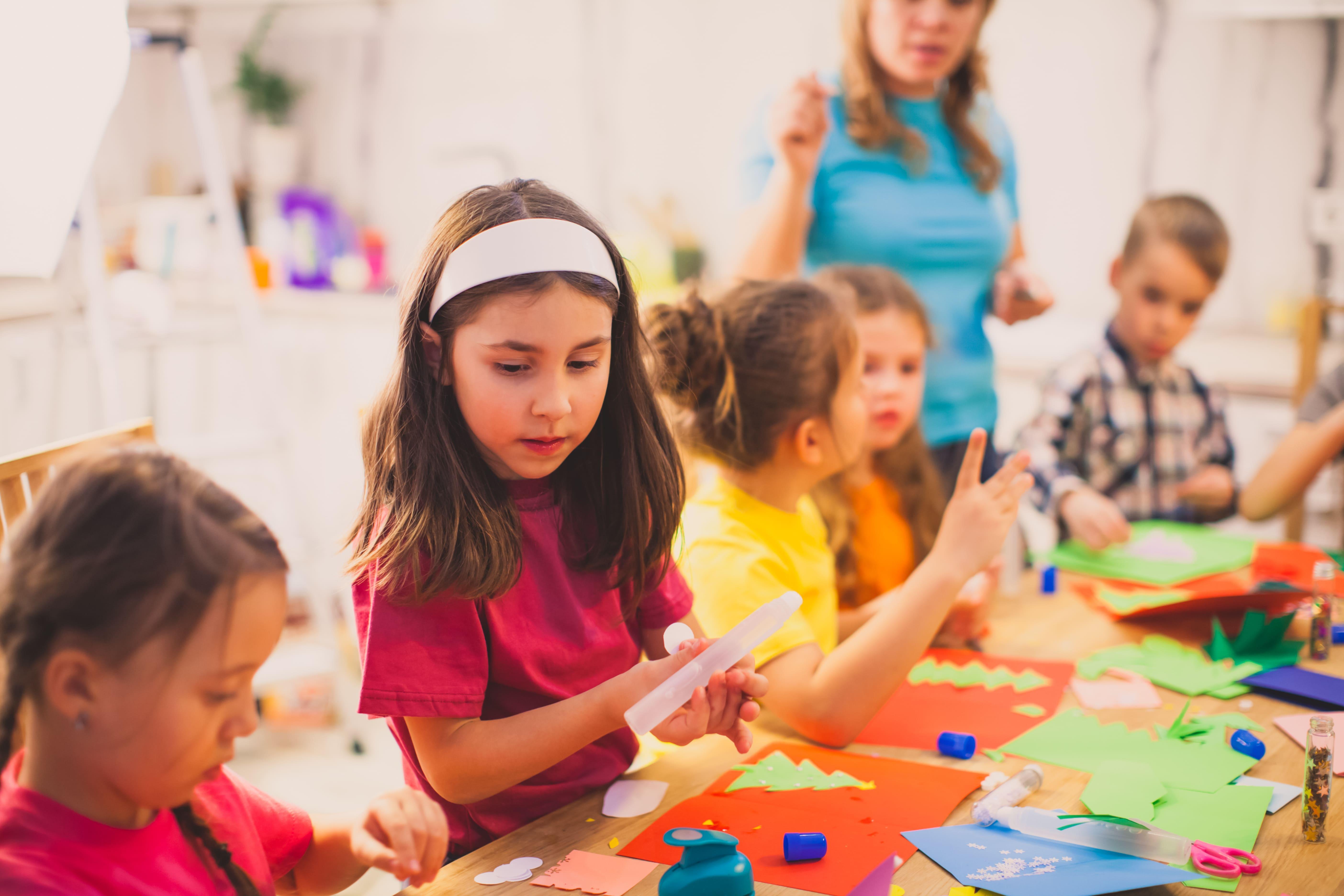 Children taking part in creative classroom activities with a teacher in an early years learning environment, reflecting the hands-on training and classroom experience offered by the Primary/Early Years (3-7) School-Led PGCE with QTS at the University of Chester.
