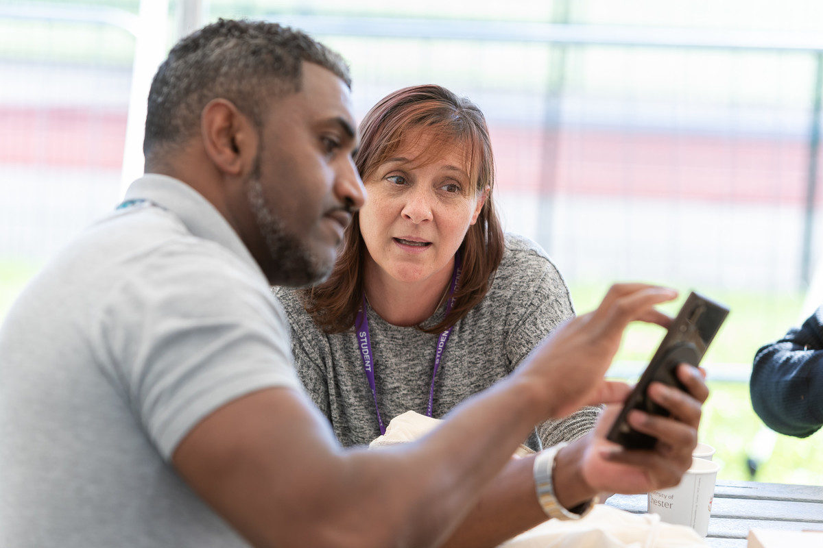 Two people using a mobile device