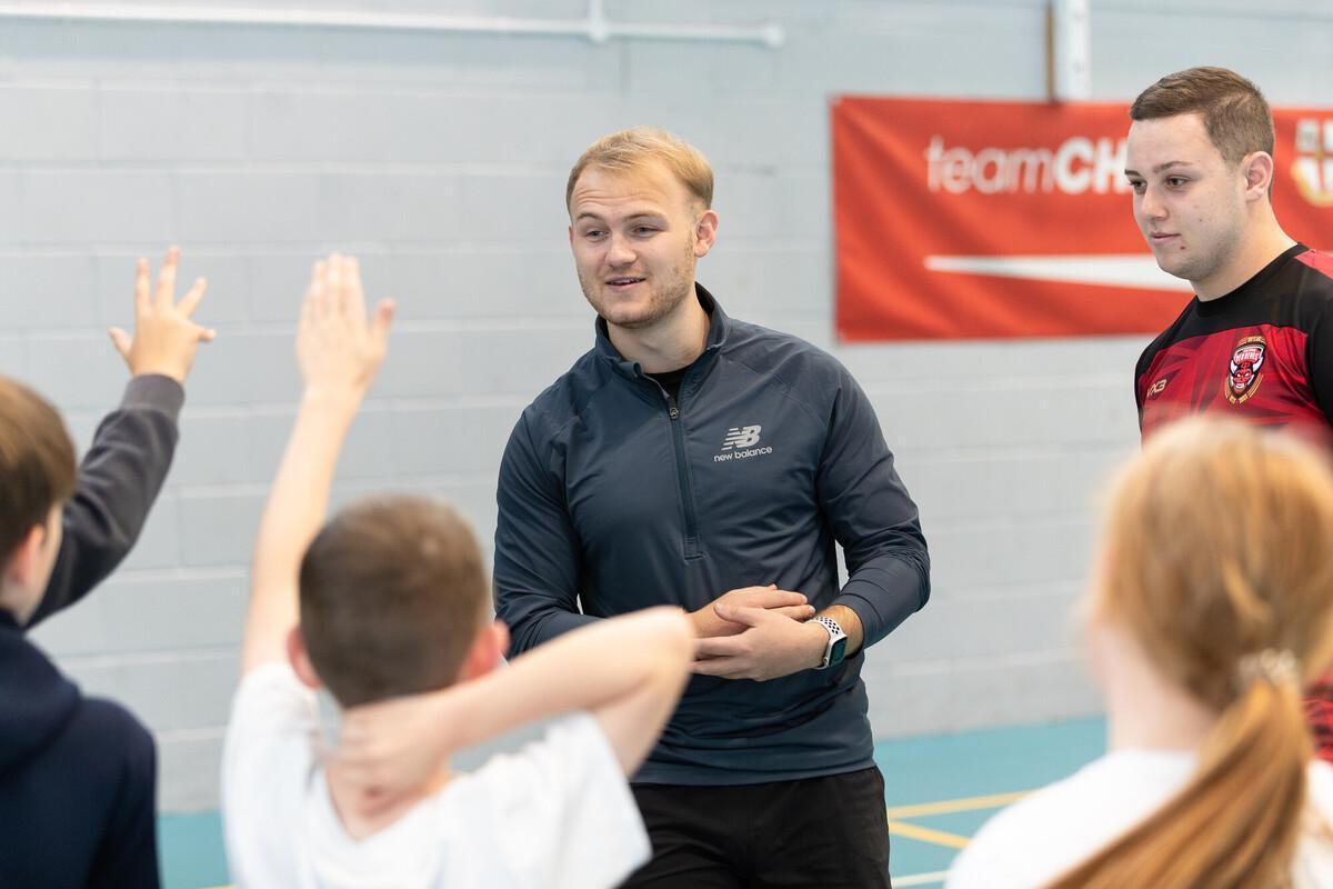Students engaging in practical sports instruction as part of the Secondary Physical Education (School-Led) PGCE with QTS at the University of Chester, preparing for careers teaching PE in secondary schools through school-based training and hands-on experience.