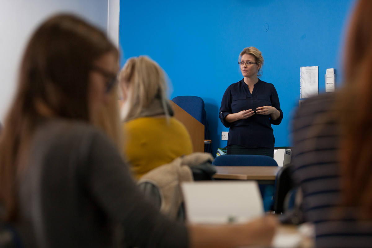 A lecturer stood in front of a class
