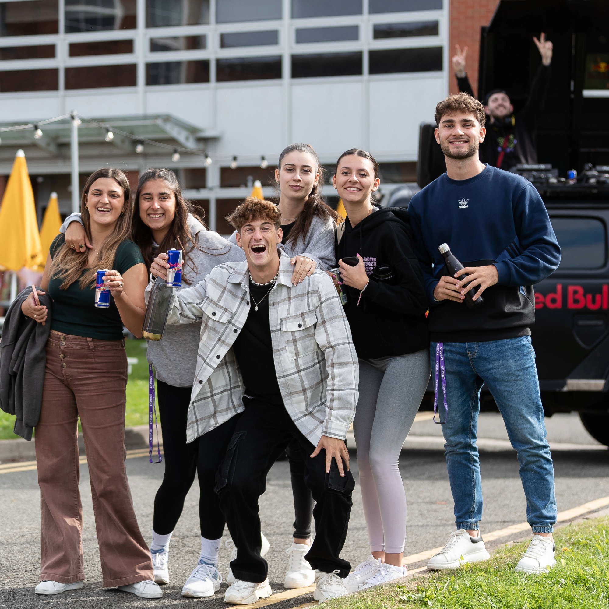 Group of students posing together outdoors during a welcome event.