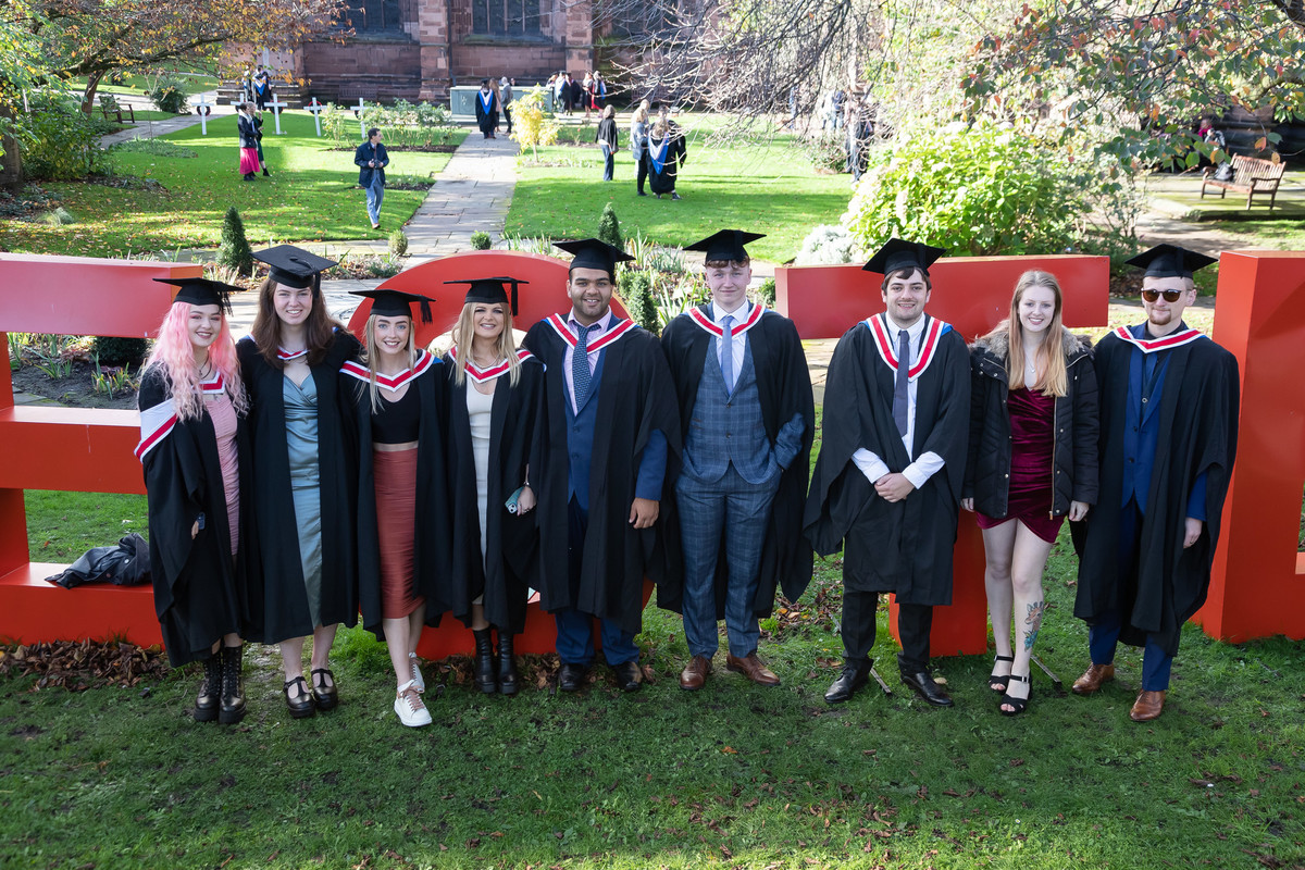 A group of people in graduation clothing standing together