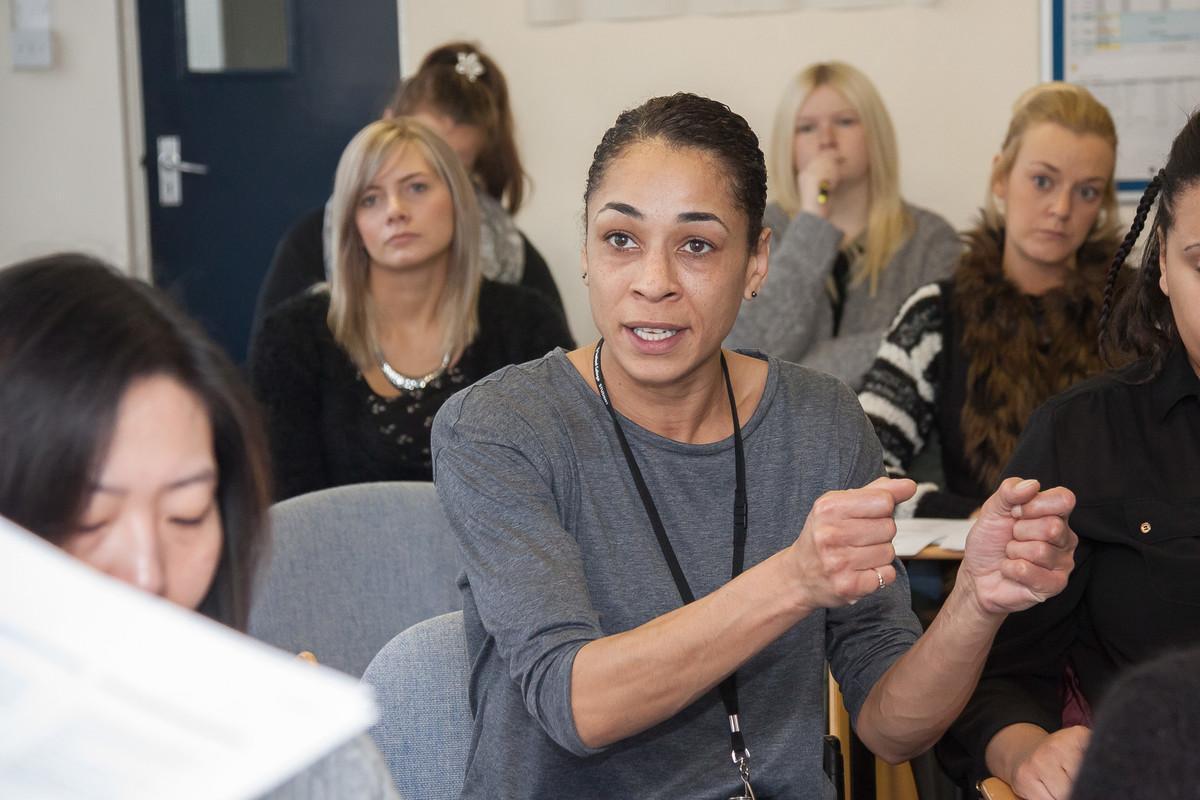 Students participating in an interactive psychology lecture, demonstrating discussion, critical thinking and behavioural analysis skills for Applied Psychology MSc study and research.