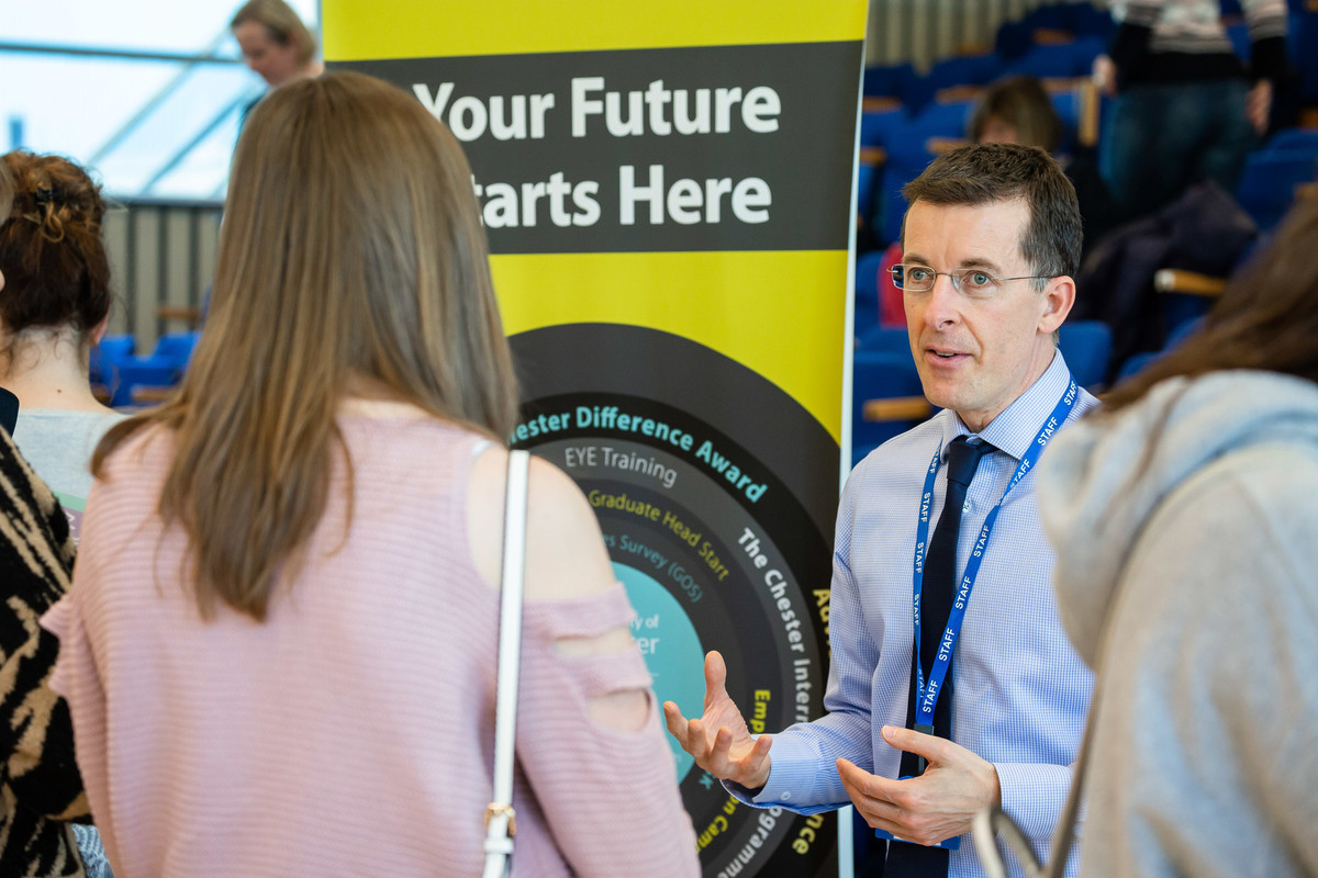 A staff member discussing with a student
