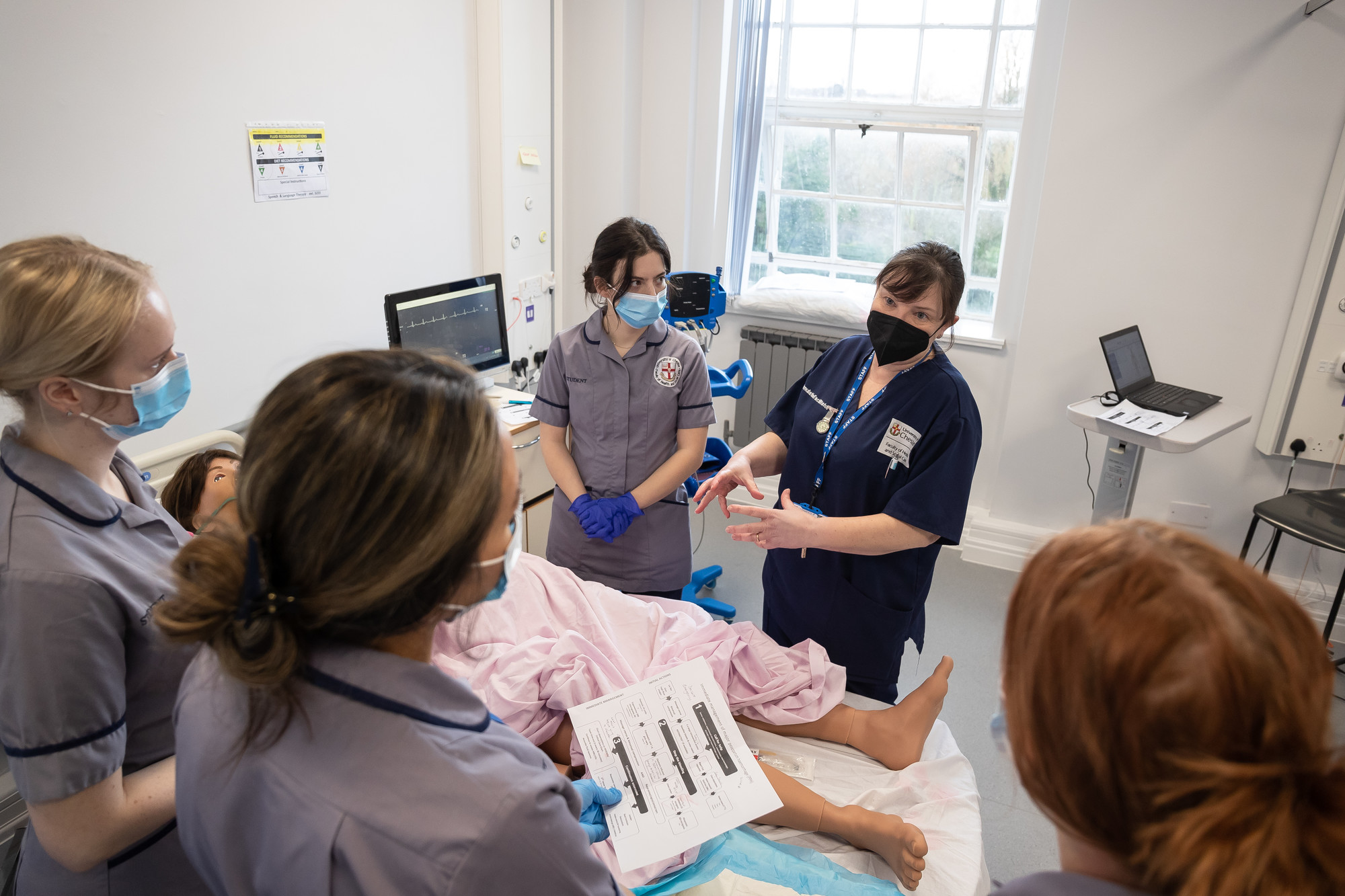 Lecturer and students in a simulation room
