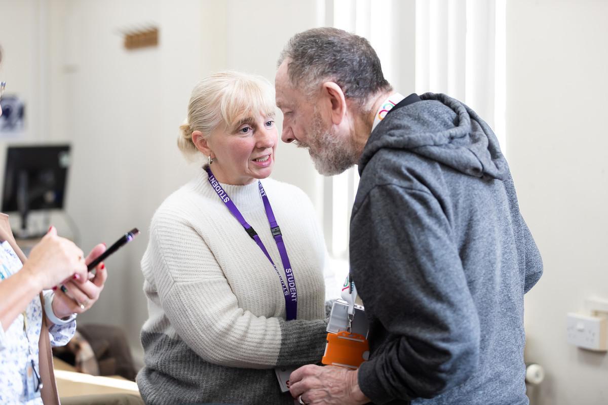 Student nurse on the Learning Disability and Mental Health Nursing MNurs (Hons) degree interacting compassionately with a service user during practical training in a healthcare setting.