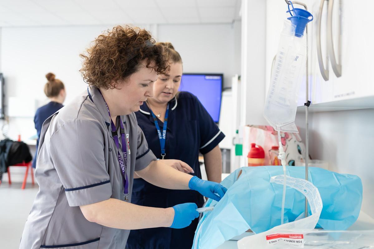 Nursing students practising advanced clinical procedures in a simulation suite at the University of Chester, reflecting the Specialist Community Public Health Nursing – School Nursing PGDip and its focus on child health, public health, safeguarding and school-based healthcare practice.