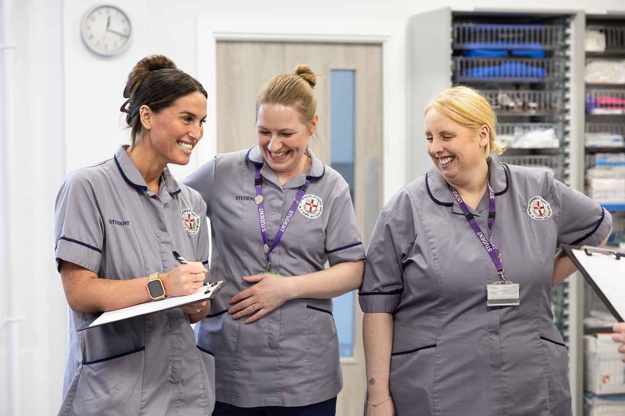 A group of nurses in discussion and making notes.