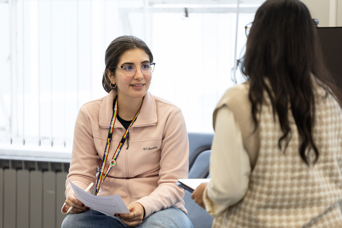 Two women are engaged in a conversation.