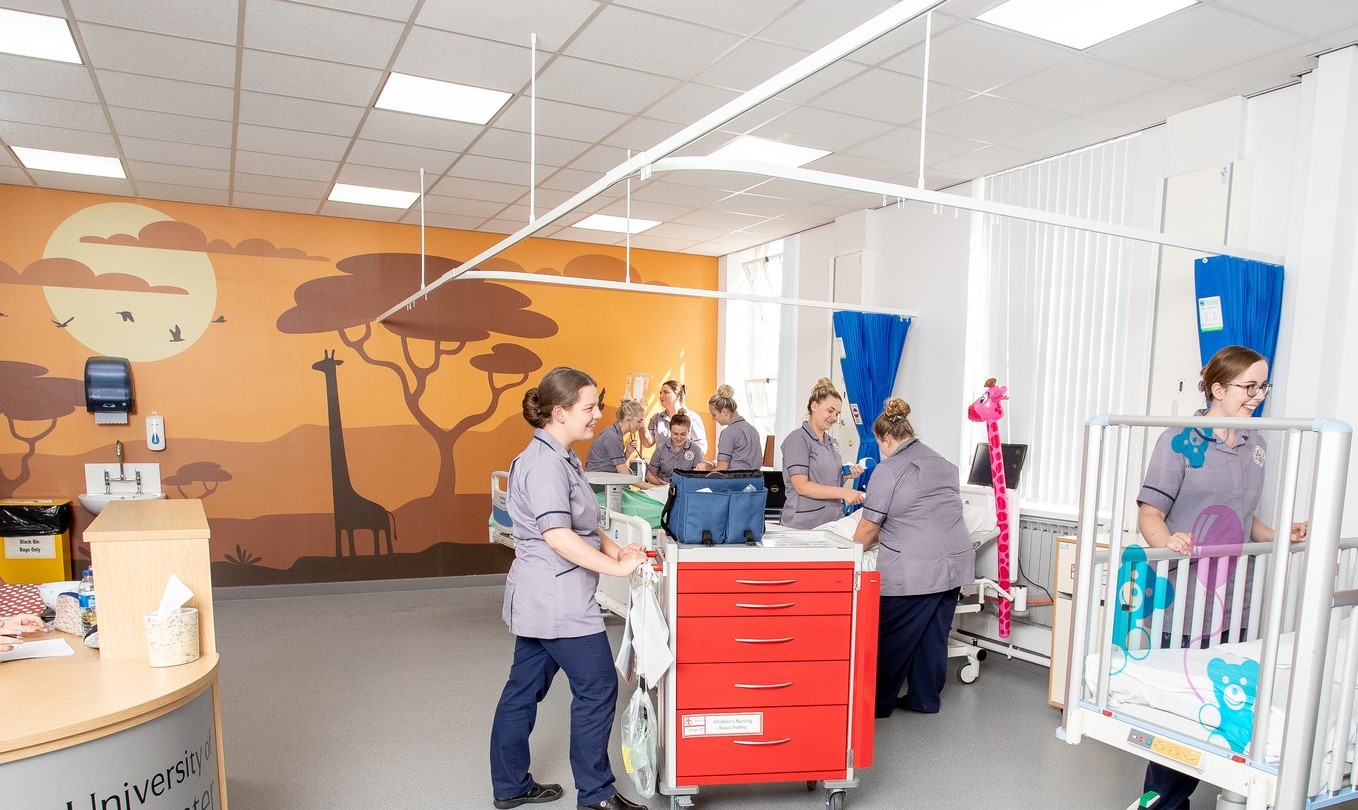 A group of nurses working on children's nursing simulation ward.