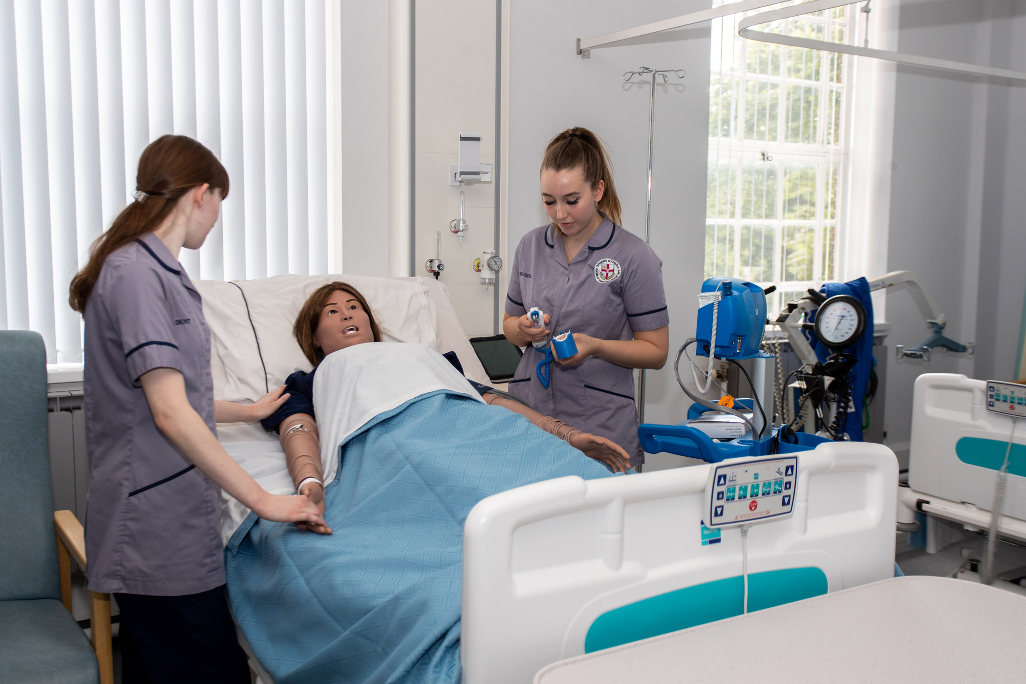 A group of students in a nursing skills lab