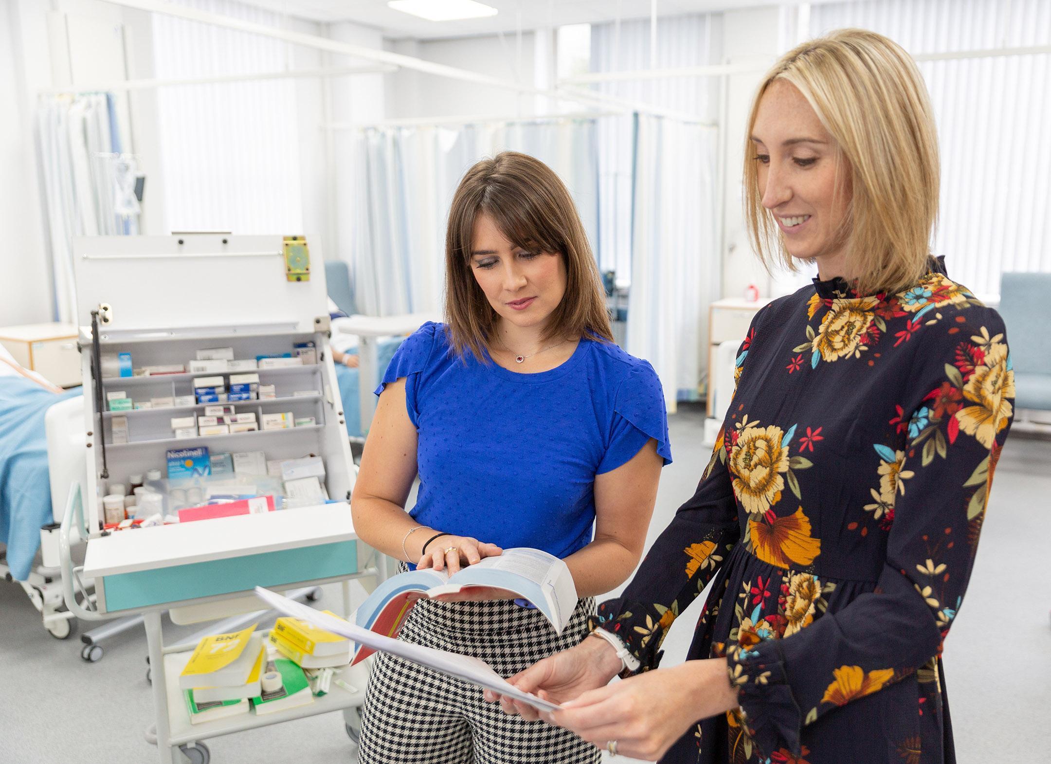 Healthcare professionals reviewing prescribing information in a clinical setting, representing the Non-Medical Prescribing course at the University of Chester.