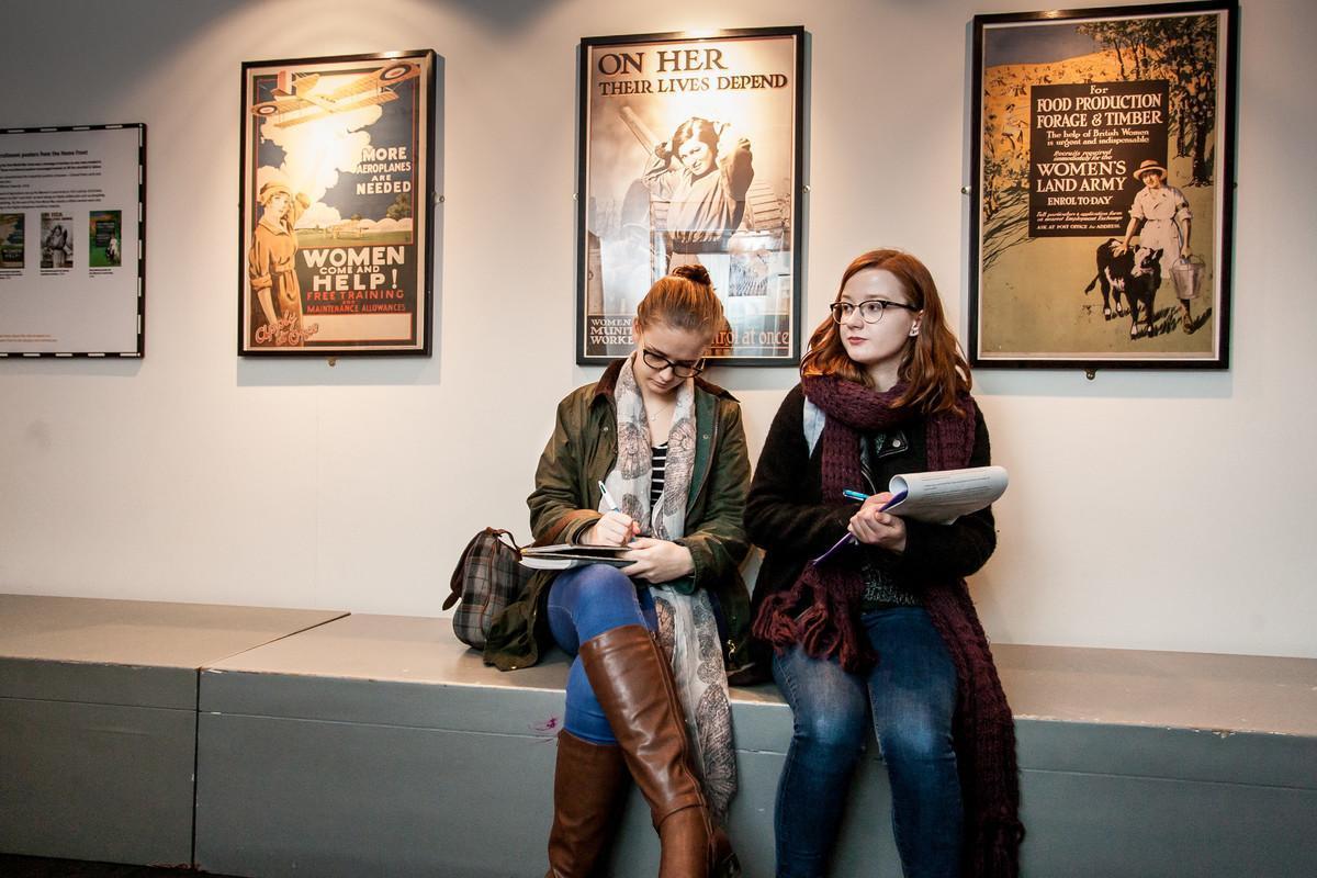 History MRes students conducting archival research in a museum exhibition space, analysing historical sources and heritage materials as part of advanced historical research at the University of Chester.