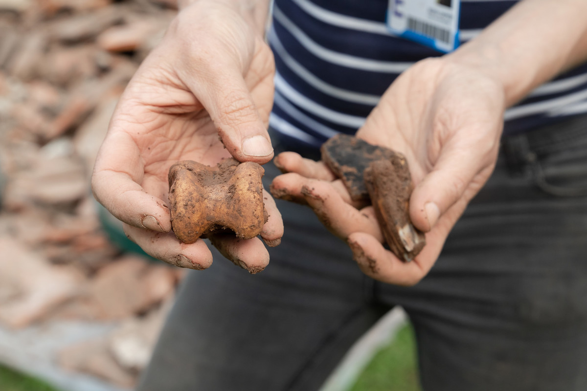 A student holding excavated items