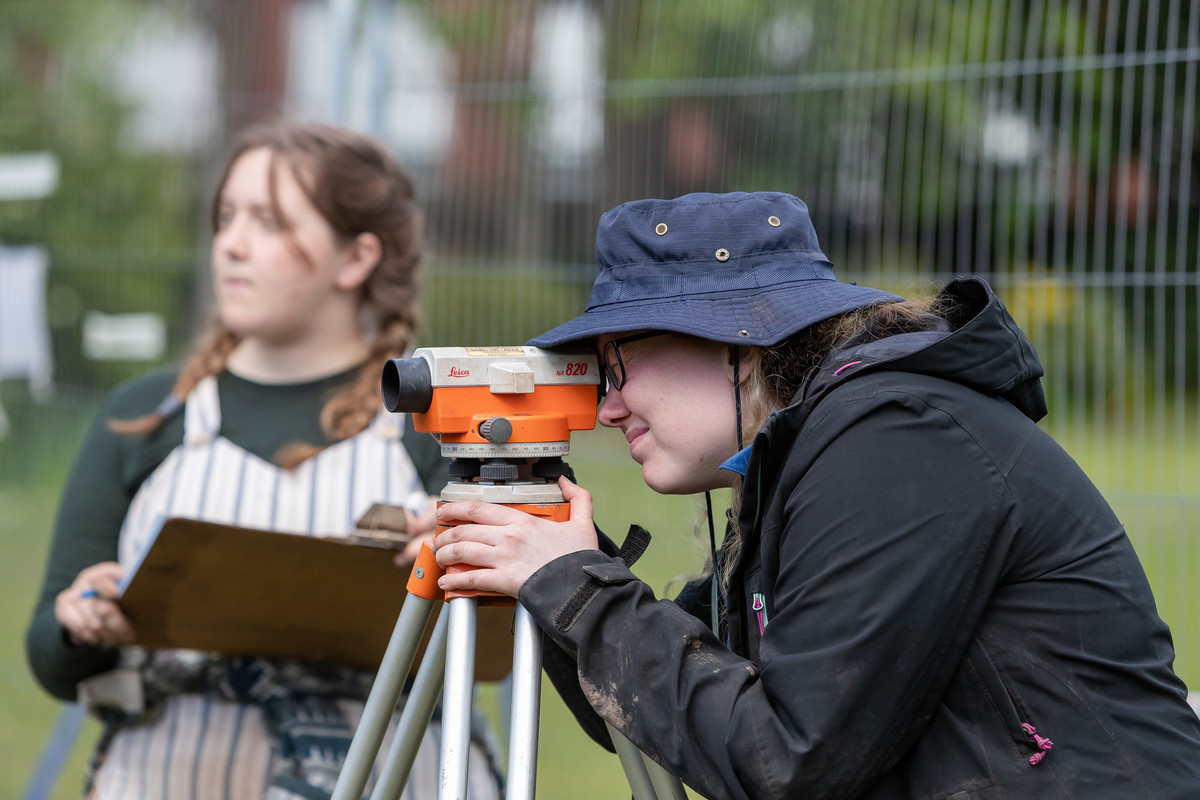 Two people surveying a site.