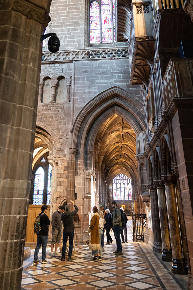 Photograph showing students inside Chester Cathedral studying the architecture above.