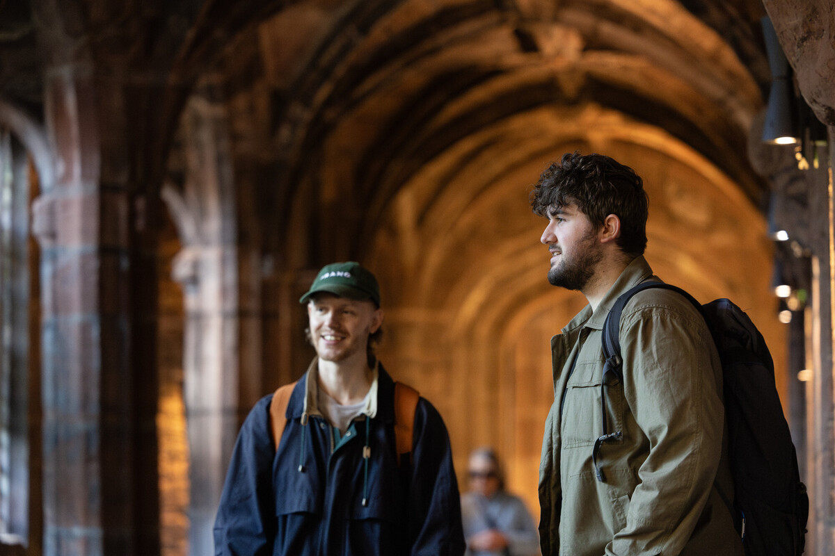 Students on a history field trip walking through a medieval stone cloister in Chester, showcasing immersive learning and on-site heritage exploration for a History BA degree programme.